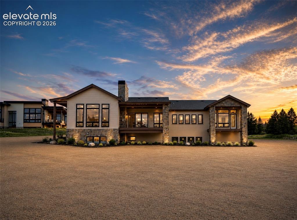 Mountain Modern design sets the standard for luxury living in northern Colorado Springs * The exterior presence will stop you in your tracks, BOLD ROOFLINES, natural stone & stucco, gorgeous modern garage doors & professional front landscaping completed at closing deliver curb appeal that simply cannot be replicated * This is not production building, this is genuine craftsmanship where every material is hand-selected, every detail deliberately executed & every finish speaks to a level of quality that must be experienced in person * Once inside, the wow factor is immediate, soaring beamed ceilings, expansive walls of glass, wide-plank hardwood floors & an open-concept great room with focal fireplace flows with effortless elegance * Gourmet kitchen is the heart of this home boasting a large center island with breakfast bar, top-tier stainless appliances, custom cabinetry, solid surface tops & convenient pantry storage that marries beauty with serious function * Gracious dining space transitions seamlessly to the covered outdoor entertaining deck, extending the living space & inviting Colorado's four seasons inside * The primary suite is a private retreat unlike anything else featuring a luxurious 5-piece bath with free-standing modern tub, designer tile work, double vanity, custom spa shower & custom walk-in closet that will genuinely impress * A second main-level bedroom with private bath & convenient home office deliver the flexibility that today's buyers demand * Custom staircase to lower level is where the home truly separates itself * Family room anchored by a full wet bar with custom finishes, two additional ensuite bedrooms with walk-in closets a plus * HUGE 3-4 car attached garage * Cul-de-sac setting adjacent to open space, pleasant views & the quiet privacy in this premier northern community * This BRAND NEW home will be completed the end of July 2026 * Look now, True custom DNA, refined finishes & a functional layout that lives as beautifully as it looks...