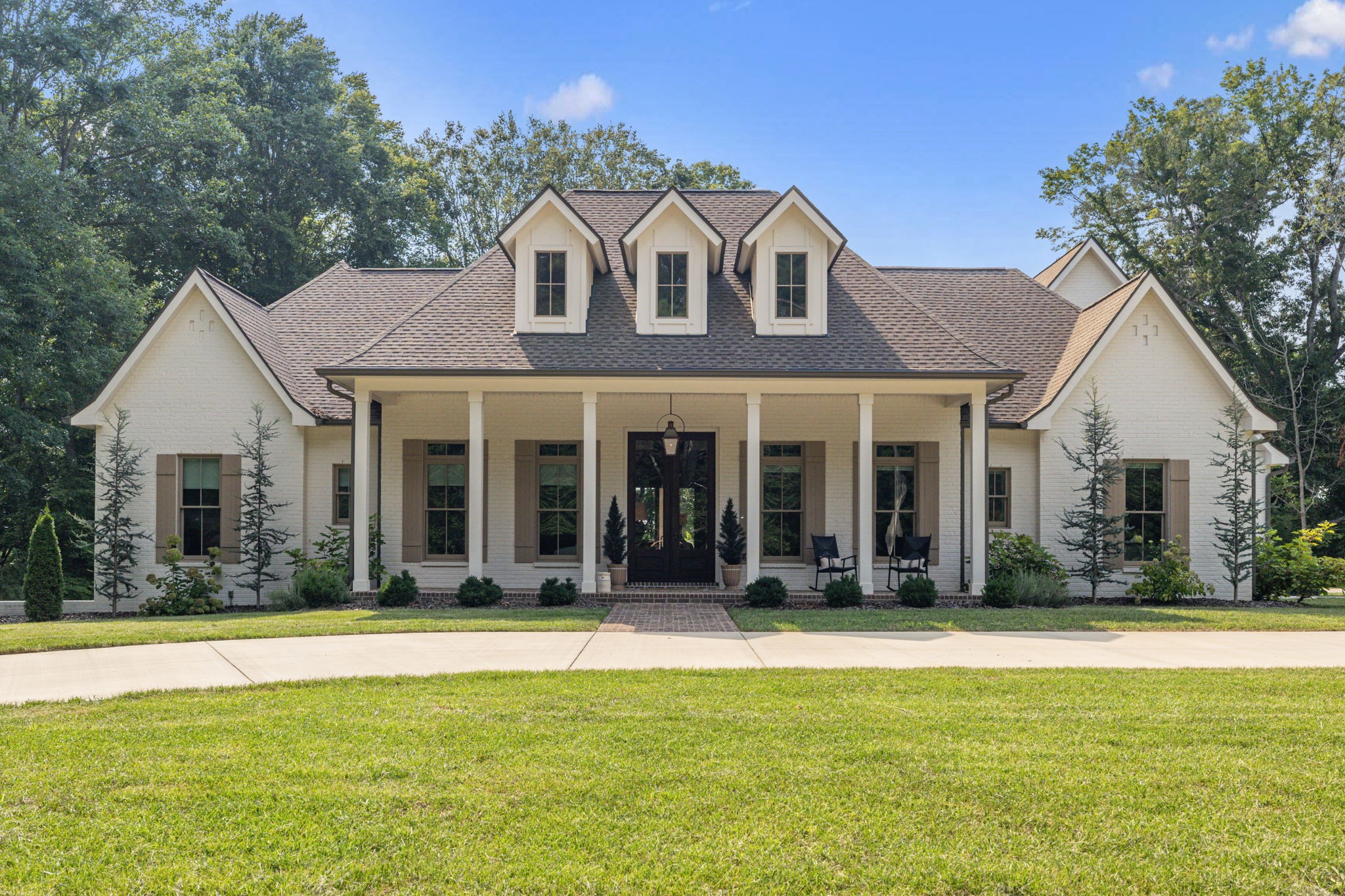 Welcome to one of Montgomery County’s premier luxury estates! Nestled on nearly 4 breathtaking acres in the highly sought-after Port Royal area, 4219 Sadlersville Rd offers an extraordinary blend of timeless craftsmanship, modern technology, and peaceful country living just minutes from Clarksville. This spectacular custom-built home features 8,123 sq. ft., 5 bedrooms, 4 full baths, and a half bath with an exceptional floor plan designed for both comfortable everyday living and grand-scale entertaining. Gorgeous covered porches overlook the beautiful grounds, creating incredible outdoor living spaces that are perfect for relaxing or hosting family and friends. Pictures truly speak a thousand words, but this is a home that must be experienced in person to fully appreciate the attention to detail. Features include soaring 10-foot ceilings, superior basement walls construction, aluminum-clad windows, grand walk-out sliding doors, custom interior shades, a stunning 100-year-old 3-inch thick red oak antique entry door with original hardware, Bevolo gas lantern, and an oversized 5-car garage with additional space for a workshop, hobby area, or home gym. The chef-inspired kitchen with luxury appliances, a 36-inch BlueStar dual-fuel gas range with pot filler, Quartz leathered countertops, and a spacious walk-in pantry. The luxurious primary suite offers dual custom-organized walk-in closets with direct access to the laundry room. Additional amenities include a whole-house water filtration system, reverse osmosis drinking water, Generac Generator, whole-home security system, hardwired WiFi 6 access points, hidden passageway, storm shelter/bunker, in-ground irrigation, gas fireplaces, and two laundry hookups. Enjoy an outdoor wood-burning fireplace, walk-out patio. Golf enthusiasts will love the Foresight GC Hawk Albatross simulator package. A rare opportunity.