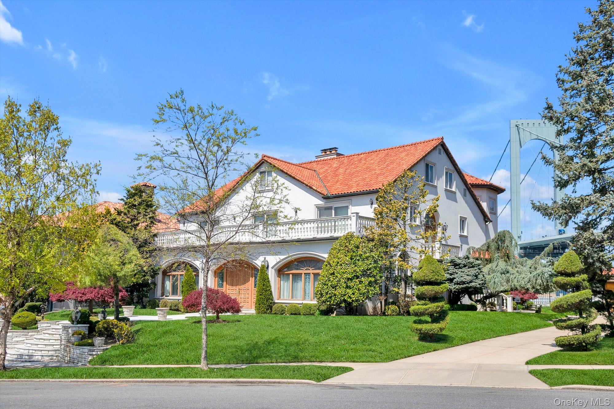 Set on a half-acre with 128 feet of direct waterfront, this 6,500 sq ft residence offers panoramic water views and a solid structural foundation. Rebuilt in 1980 with concrete and block construction, the home features detailed millwork, Kentucky oak, and Carrara marble flooring—preserve its distinctive elements while making the rest your own private oasis. Nearly every room captures waterfront and bridge views,  where the water creates a sense of calm and fills the home with natural light.The main level features a gracious entry foyer with coat closet, Large EIK with center island, a formal dining room with custom built-ins and sliding doors to a waterfront patio, a formal living room with fireplace, a den, a sunken sitting room, a private office/bedroom, and powder room. The second level offers four spacious en-suite bedrooms, an additional full bathroom, and an impressive bonus room with soaring 25-foot ceilings. The third floor provides separate living quarters with private exterior access, and features two bedrooms, a full bathroom, a large living/game room, and multiple storage rooms—ideal for extended family or guests.The basement includes both a sauna and a steam room for a private, spa-like experience.A long and wide driveway leads to a six-car garage. Additional highlights include CAC, central vacuum, a large balcony, Romeo and Juliet balconies, Closets galore all cedar-lined, Sliding doors to back yard patio, remarkably low taxes and more.For boating enthusiasts, nearby dockage is available.