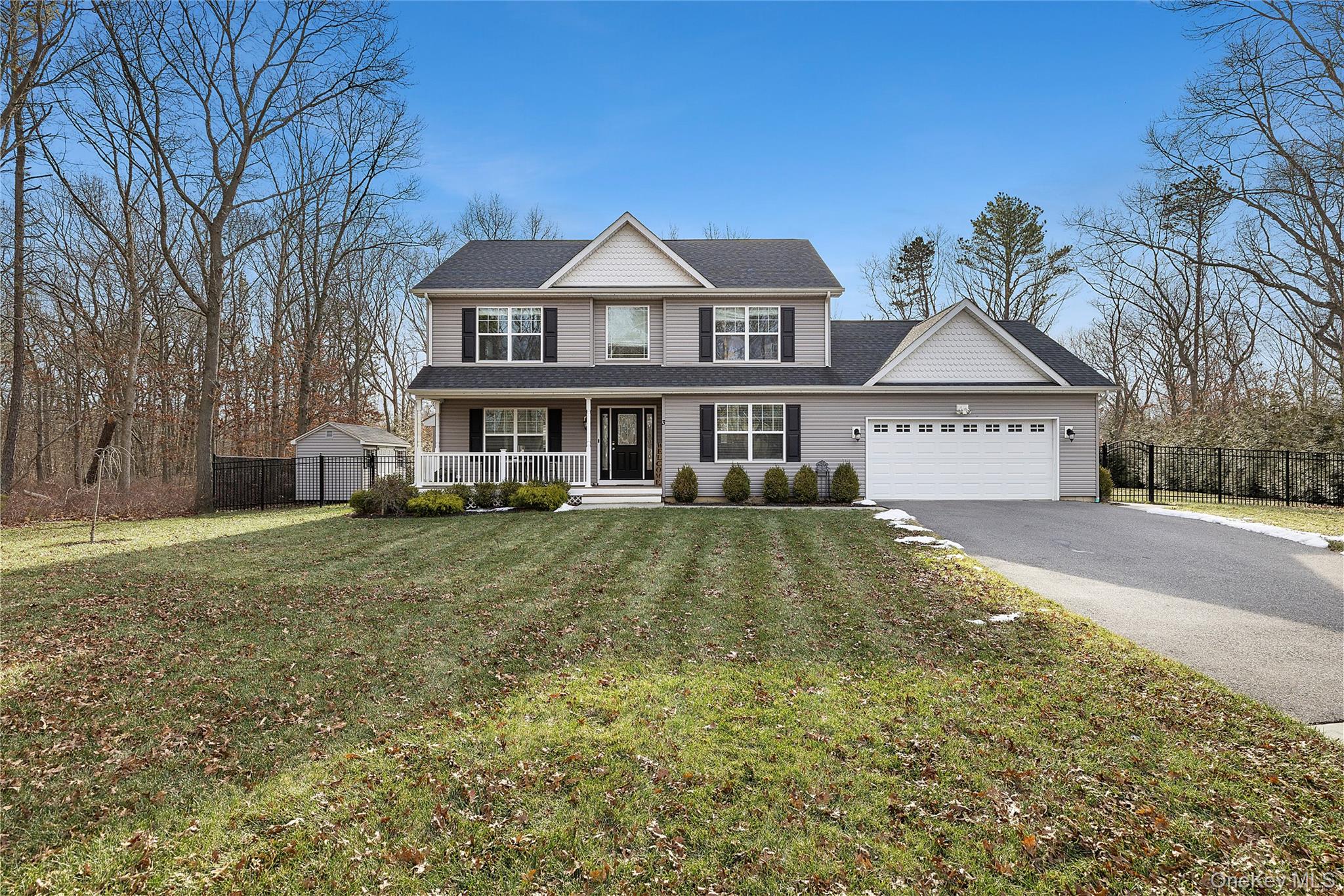 Welcome to this exceptional 2020 built Colonial situated on a cul-de-sac in Manorville within the sought after East Moriches School District. This nearly new residence offers 4 bedrooms and 2.5 baths on a private 1.25 acre lot with a 2 car garage. The main level features an eat in kitchen with granite countertops, hardwood floors throughout, a formal dining room, living room, den with gas fireplace, and half bath. The second level includes all 4 bedrooms, 2 full bathrooms and a washer and dryer for added convenience. Additional features include gas utilities and a full basement. The backyard is designed for entertaining and relaxation, featuring an 18 x 38 in-ground heated saltwater pool and paver patio. A turnkey opportunity offering space, privacy, and modern finishes in a desirable setting.