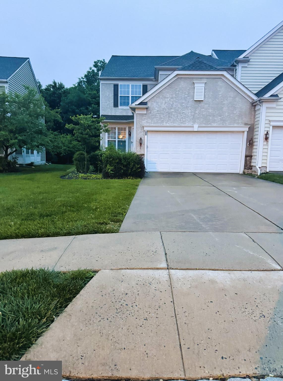 Welcome to Longford Crossing and this beautifully maintained luxury carriage-style townhouse. The home features a formal entry, hardwood floors, tile and carpeted areas, high ceilings, crown molding, and an open main level designed for modern living. The spacious living room flows into a large eat-in kitchen with tall cherry cabinets, quartz countertops, a center island, recessed lighting, and a gas fireplace. A dedicated home office and convenient powder room complete the main level.The finished lower level offers approximately 650 sq ft of additional living space, ideal for a recreation room, media area, or guest space (not included in above-grade square footage; buyer to verify permits and measurements). Upstairs, the primary bedroom suite includes a tray ceiling, dressing area, walk-in closet, and a large bathroom with a jetted tub. Two additional bedrooms, a full bathroom, and second-floor laundry complete the upper level. Additional highlights include a two-car garage, well-manicured lawn, and a large rear deck backing to mature trees. Community amenities include sidewalks, playgrounds, walking trails, and a low monthly HOA fee.