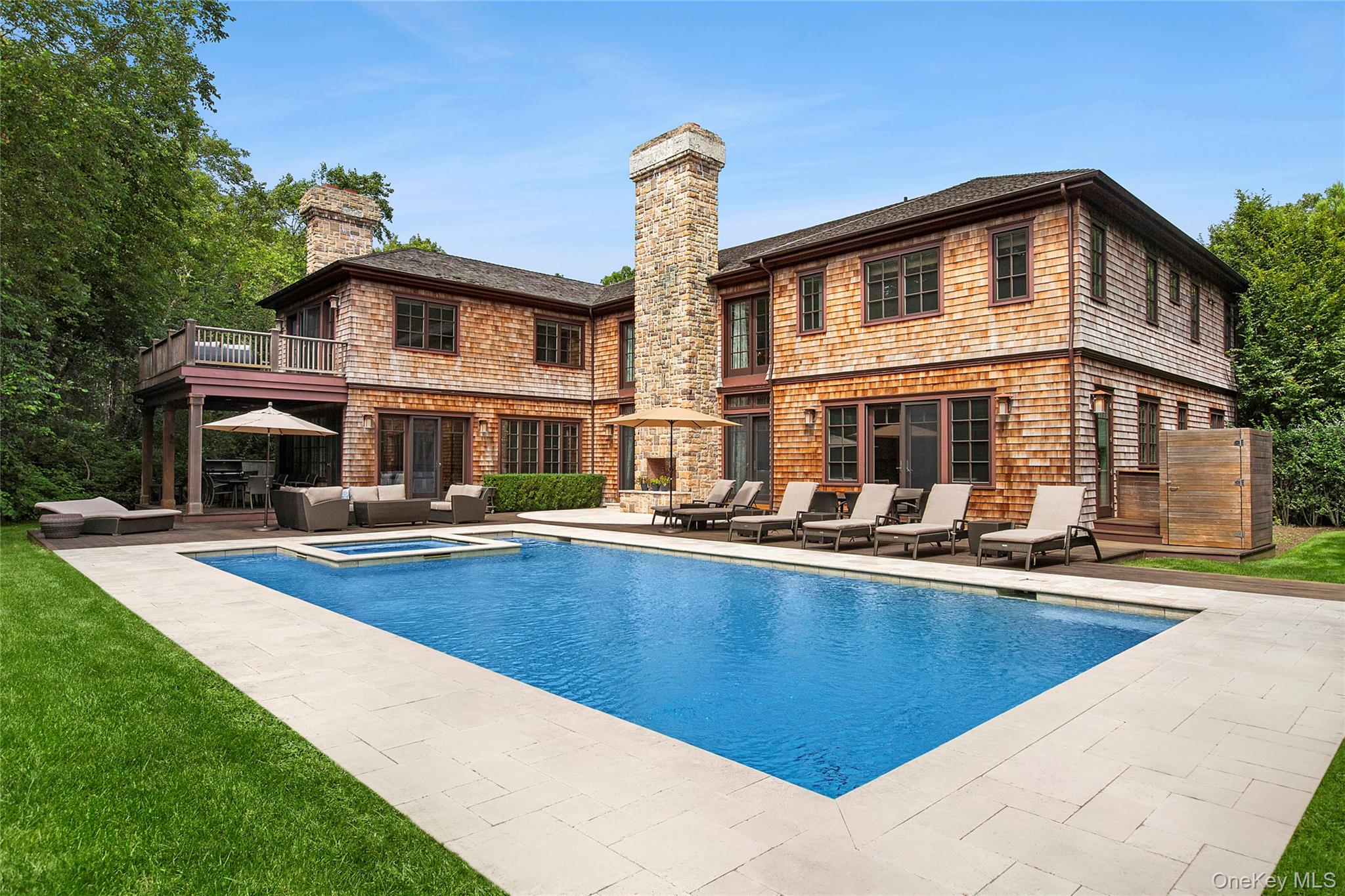 This turnkey property includes all furnishings, creating a truly move-in-ready experience. Nestled in the Prestigious "Devon Colony" area of Amagansett on 1.5 acres sits this +/- 6700 sq ft. Resort style Tuscan Masterpiece. Built by master builder Richard Perello, this State of the art Green Home involves high end quality construction and immaculate woodworking and detail. The expansive and open floor plan, includes 7 bedrooms and 6 bathrooms with 2 additional 1/2 baths on the first floor. The entrance leads to a grand living room with a massive fireplace with beautiful stone accents, a 28 foot cathedral ceiling with second floor balcony and custom glass skylight allowing for an abundance of Natural light. With an open floor plan and chef's kitchen this fully automated home lends itself for entertaining and easy resort style living. The master bedroom has cathedral ceilings, a huge master bath with a country club size shower and massive vanity. The lower level is an entertainer's dream, designed for fun and leisure. Enjoy a spacious recreation room featuring a dry bar, a media area with surround sound, lots of storage space and two additional bedrooms, providing ample space for gatherings and relaxation.The home comes equipped with a full Control4 home automation system with endless possibilities and complete remote access to your home from your computer. The outdoors are complimented with a 20 x 40 gunite pool with a 10 x 10 spa with spillover edges. The outdoor fireplace and combination of mahogany decks and travertine patios truly finish off this resort style backyard. Rinse off in the Mahogany accented outdoor shower or run in the large rear lawn on your way back from the beach or the Devon Yacht club.