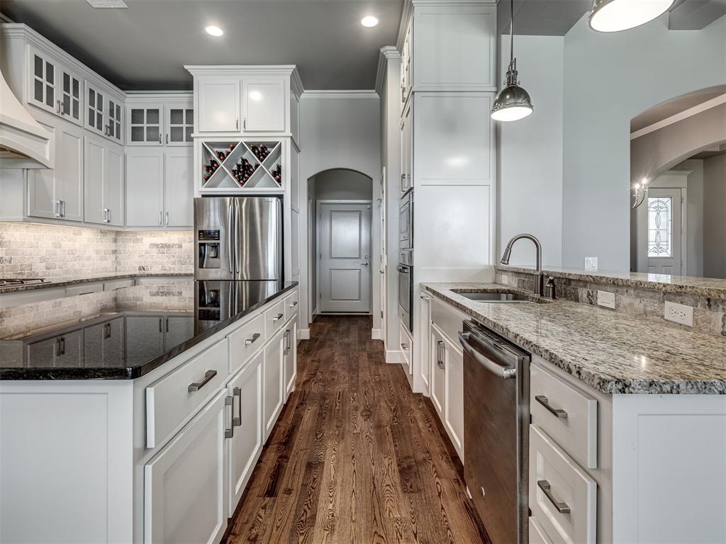 Welcome home to 4211 Cordova Ct. in the coveted Las Colinas Addition. This lovely 5 bedroom, 4 full bathroom home is thoughtfully planned and the layout is ideal. With 4 downstairs bedrooms (or 3 bedrooms + study) and another (5th) upstairs, this layout allows for private spaces for all who live here.  Bathrooms are ideally located near each bedroom, with one being a Jack and Jill bathroom.  Enjoy your own private oasis in the primary suite with a soaking bathtub, oversized walk in shower, double vanities and make-up sitting area. The primary bathroom is complete with ample storage, built in cabinetry and 2 walk-in closets; built-in dresser and shelves complete the walk-in closet. Plenty of counter space in the kitchen with an island makes hosting your holiday gathering a blast! Everyone always congregates in the kitchen! The kitchen is complete with a pot-filler, wine racks, built-in cook top, oven, microwave, and walk-in pantry.  The fun continues in the upstairs bonus area with a full bathroom, a separate 5th bedroom with walk-in closet, perfect for someone needing more independence.  The layout is ideal for access to both garages from the interior, and is complete with a garage floor storm shelter. This is a must see, must have home!