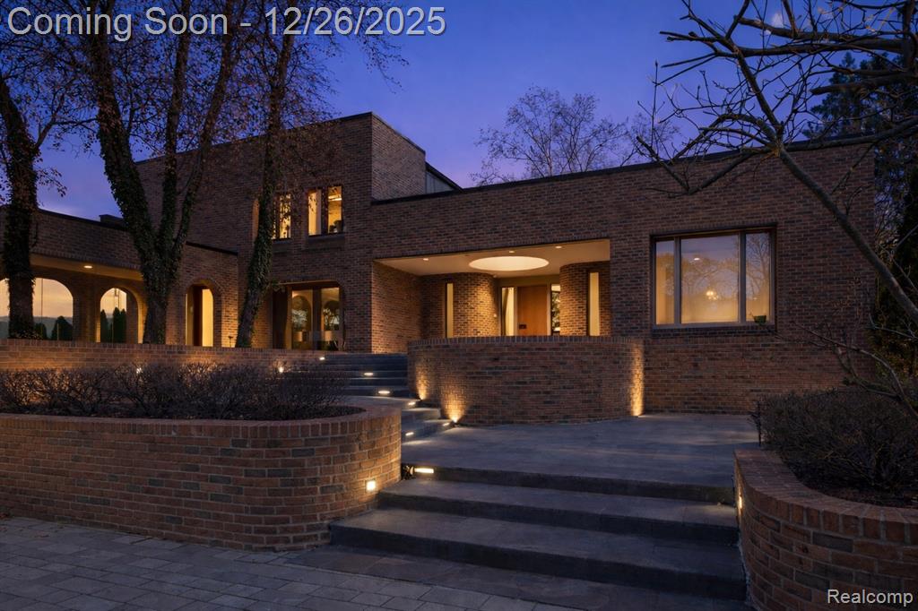 Introducing an original Tobocman-designed architectural estate on All-Sports Orchard Lake, set on approximately 1.2 acres with nearly 100 feet of direct lake frontage, featuring a rare indoor pool, walkout lower level, and a highly desirable first-floor primary suite, all adjacent to Orchard Lake Country Club. This iconic waterfront residence blends bold architectural expression with expansive scale and seamless indoor–outdoor living within one of Michigan’s most prestigious and tightly held lakefront settings. The main level impresses with dramatic volumes, sculptural ceilings, and walls of glass framing sweeping lake views throughout the primary living spaces. Multiple gathering areas and a formal dining room with distinctive arched window detailing offer an ideal balance of everyday comfort and refined entertaining, while the kitchen and service areas are designed for functional efficiency in support of a hospitality-driven lifestyle. The walkout lower level delivers a true estate-level experience, highlighted by the indoor pool beneath skylit ceilings, expansive recreation and lounge areas, and direct access to the lakefront grounds. Outdoor terraces and curated landscaping extend the living experience to the shoreline, creating exceptional spaces for entertaining, relaxation, and all-sports lake living. The first-floor primary suite offers privacy, abundant natural light, a private terrace, and a custom marble bath. Additional bedroom suites are thoughtfully positioned to provide comfort and separation for family and guests. A rare opportunity to own an architecturally significant lakefront estate defined by scale, privacy, and premier positioning on Orchard Lake. Select images have been virtually staged and digitally enhanced. BATVAI.