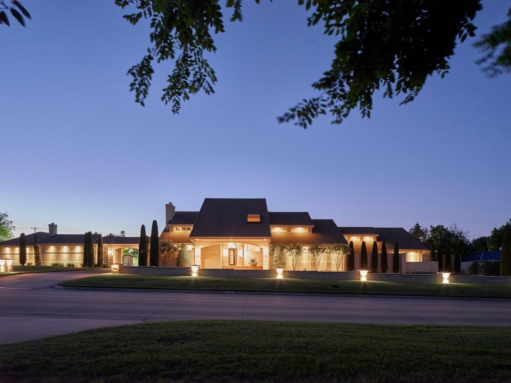 Come see this contemporary masterpiece situated on an expansive 1.2-acre lot in Nichols Hills.  Designed for the most discerning buyer, this private estate offers a seamless blend of luxury and functionality. A decorative concrete circle drive with landscape lighting provides a welcoming entrance for guests.  The gated breezeway leads to a parking court, seven car garage, lighted paddle tennis court, & newly constructed dog house with fenced in run.Walking through the front door, you will be blown away by the raised ceilings, beautiful hardwood floors, and stunning cast stone fireplace.  Large windows across the back of the house flood this home with tons natural light while providing stunning views of the pool & backyard oasis. The floorplan includes a sophisticated office/library, multiple living rooms, formal dining room, and chef’s kitchen.  The kitchen is equipped with custom cabinetry, TurboChef Viking double ovens, a Miele six-burner gas range with griddle, and galley sink.  A stunning wet bar, complete with wine fridge & ice maker, is ideally located for entertaining. All four bedrooms are on the main level, each with its own ensuite bathroom.  The primary suite features an attached sitting room for reading a book or watching TV.  A spacious primary bathroom includes a walk-in shower, bath tub, double vanities, and a large his & her walk-in closet.Two of the bed rooms are located on the opposite side of the home from the primary suite and share an additional den or family room. Upstairs is a large media & game room with projector, built in speakers, a wet bar, and full bathroom. An 8ft concrete privacy wall surrounds the backyard & it's beautiful saltwater pool.  The stunning landscaping, outdoor kitchen, and multiple patios make this the perfect outdoor space for entertaining guests. This estate is a true showstopper, offering unparalleled scale and privacy, don’t miss out!