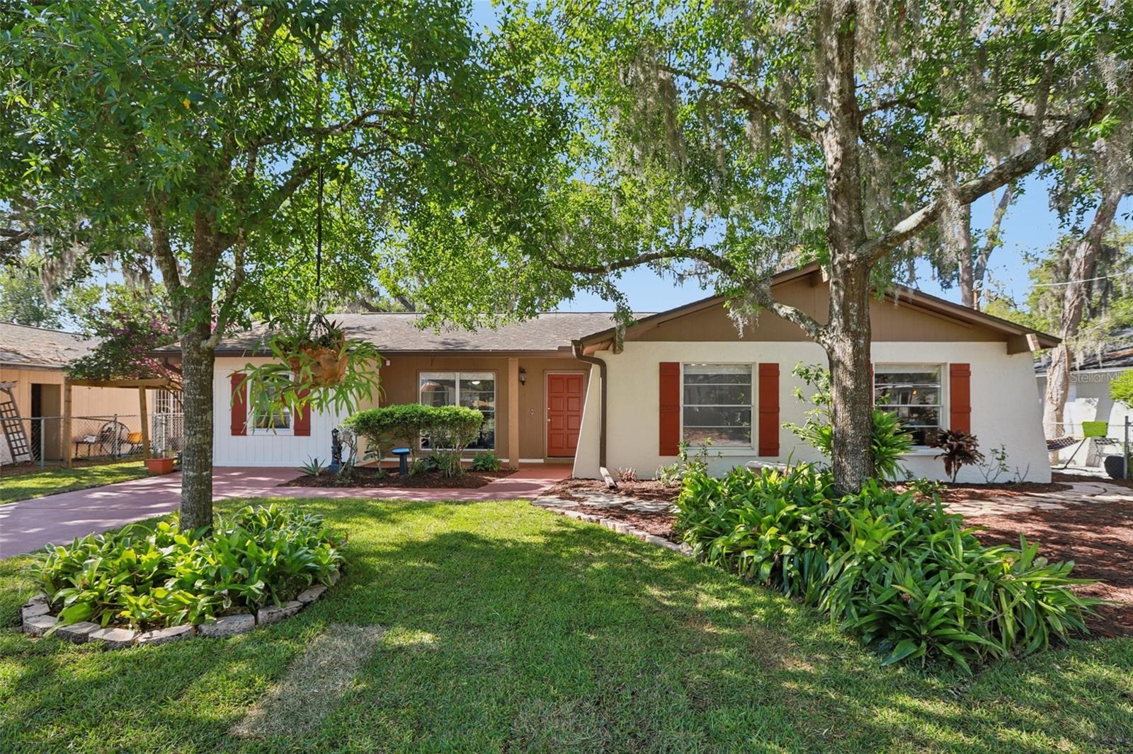 MOVE-IN READY AND BEAUTIFULLY MAINTAINED, this charming 5-BEDROOM HOME on Okara Rd near Temple Terrace offers the perfect blend of comfort, style, and flexibility—with NO HOA OR CDD RESTRICTIONS. From the moment you step inside, you’ll notice the light and bright atmosphere, enhanced by FRESH INTERIOR PAINT AND BRAND-NEW LUXURY VINYL PLANK FLOORING THROUGHOUT—COMPLETELY CARPET-FREE for easy maintenance and a modern look.The kitchen is both inviting and functional, featuring GRANITE COUNTERTOPS, A STYLISH TILE BACKSPLASH, AND CRISP WHITE CABINETRY that provides plenty of storage. It flows easily into the main living areas, making it ideal for both everyday living and entertaining. French doors open to the backyard, bringing in natural light and creating a seamless indoor-outdoor connection.Step outside to a GENEROUSLY SIZED, FULLY FENCED BACKYARD with plenty of space to relax, garden, or host gatherings. Enjoy the pavered patio for outdoor dining, two storage sheds for added convenience, and a charming side yard arbor adorned with bougainvillea that adds a touch of character and color.Inside, the home continues to impress with a large laundry room complete with shelving, plus a washer and dryer included. Recent updates such as a 2018 roof (With a Transferable Platinum Warranty) - 2017 HVAC system - and a newer electrical panel (2020) offer added peace of mind.Situated in a great Temple Terrace location, this home offers easy access to local parks, shopping, dining, and major roadways—making it a fantastic opportunity for anyone looking for a freshly updated, move-in ready property.