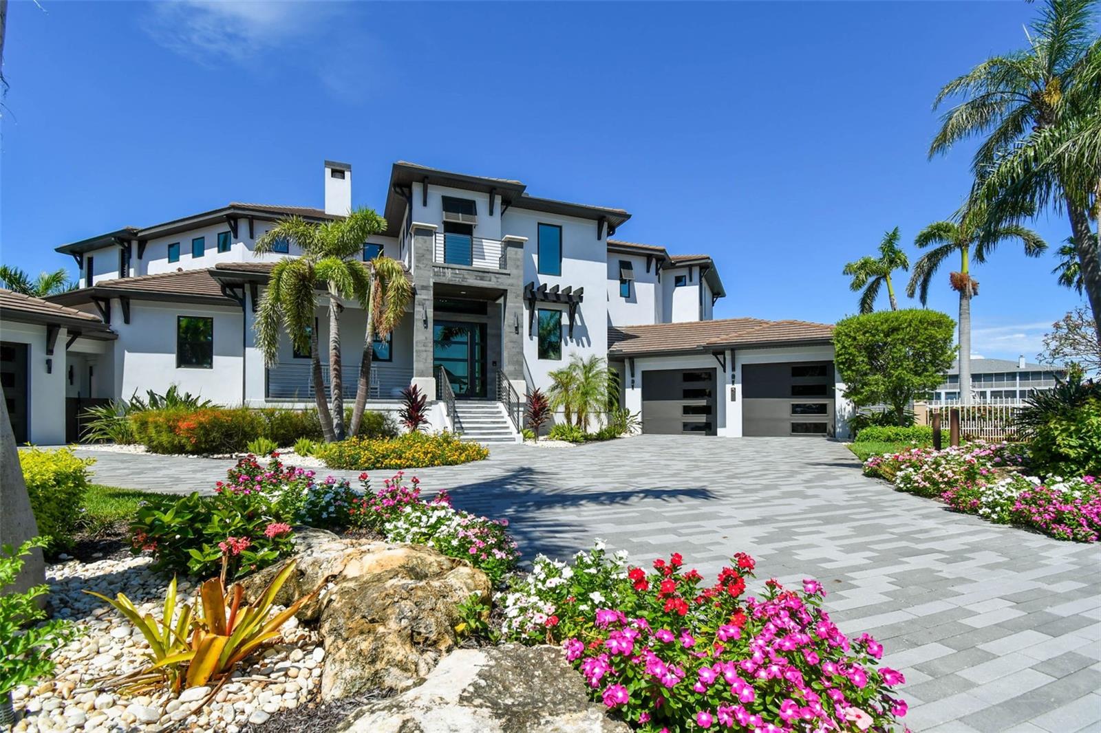 Experience the ultimate in luxury with this exquisite contemporary masterpiece located in Tierra Verde. Completed in 2020 on a half acre lot w/ 234 feet of sheltered water frontage , this breathtaking residence offers an impressive 5 bedrooms and 5 1/2 baths, encompassing over 4,846 square feet of interiors and a grand total of 8,340 square feet indoor/outdoor living. From the moment you enter through front doors, you'll be captivated by the stunning finishes that effortlessly combine elegance, luxury and taste. The glass elevator, wine cellar that holds over 500 bottles, and floor-to-ceiling pocket sliding doors leading to the pool area with its fire pots and rain curtain are just a few of the many remarkable features this home has to offer. 

Crafted for effortless integration, numerous corner sliders completely open the house to seamlessly fuse the interior and outdoor living areas.  Multiple fireplaces, comfortable sitting areas with pecky cypress ceilings, a dreamy pool complete with a swim shelf and recessed jacuzzi – every detail is carefully crafted to create an ultimate oasis. The chef's kitchen is equipped with top-of-the-line Wolf and Sub Zero appliances, gas cooking, custom solid wood cabinetry, walk-in pantry, and a large Caesarstone "primacordia" quartz countertop with waterfall edge make this kitchen a dream come true. From the dining area, you can enjoy a view of the disappearing corner of pocket sliding doors leading to an equally impressive outdoor kitchen. This space features a fabulous leather finished granite island with another waterfall edge and a built-in Evo grill. 

Upstairs, the master retreat offers a similar indoor/outdoor feel with wide plank wood floors, volume ceilings accented by rich wood beams, and a retractable ceiling-mounted TV. Step out onto the enormous waterfront deck for even more stunning views. The elegant see-through Montigo fireplace adds a touch of luxury to both the master bedroom and bath, where you will find a 55" Japanese round soaking tub, frameless glass shower, dual vanities, and designer finishes. 

For the pet enthusiast, this home offers a versatile space designed to cater to all furry family members as the 1st floor laundry includes a variety of personalized kennels, a convenient dog wash, while still maintaining the high-end touches like the quartz counters. Additionally, this magnificent property boasts 234 feet of sheltered waterfront, complete with a spacious dock equipped with power lifts (30K lbs for boat and 4.5K lbs for jet skis) just moments away from Tampa Bay and the Gulf of Mexico. Other noteworthy features include temperature-controlled garages, a rooftop deck, convenient Lutron blinds throughout, two laundry rooms (one on each floor), advanced Control4 technology, brand new seawall and countless other impressive amenities. Be sure to check out the videos for more details!