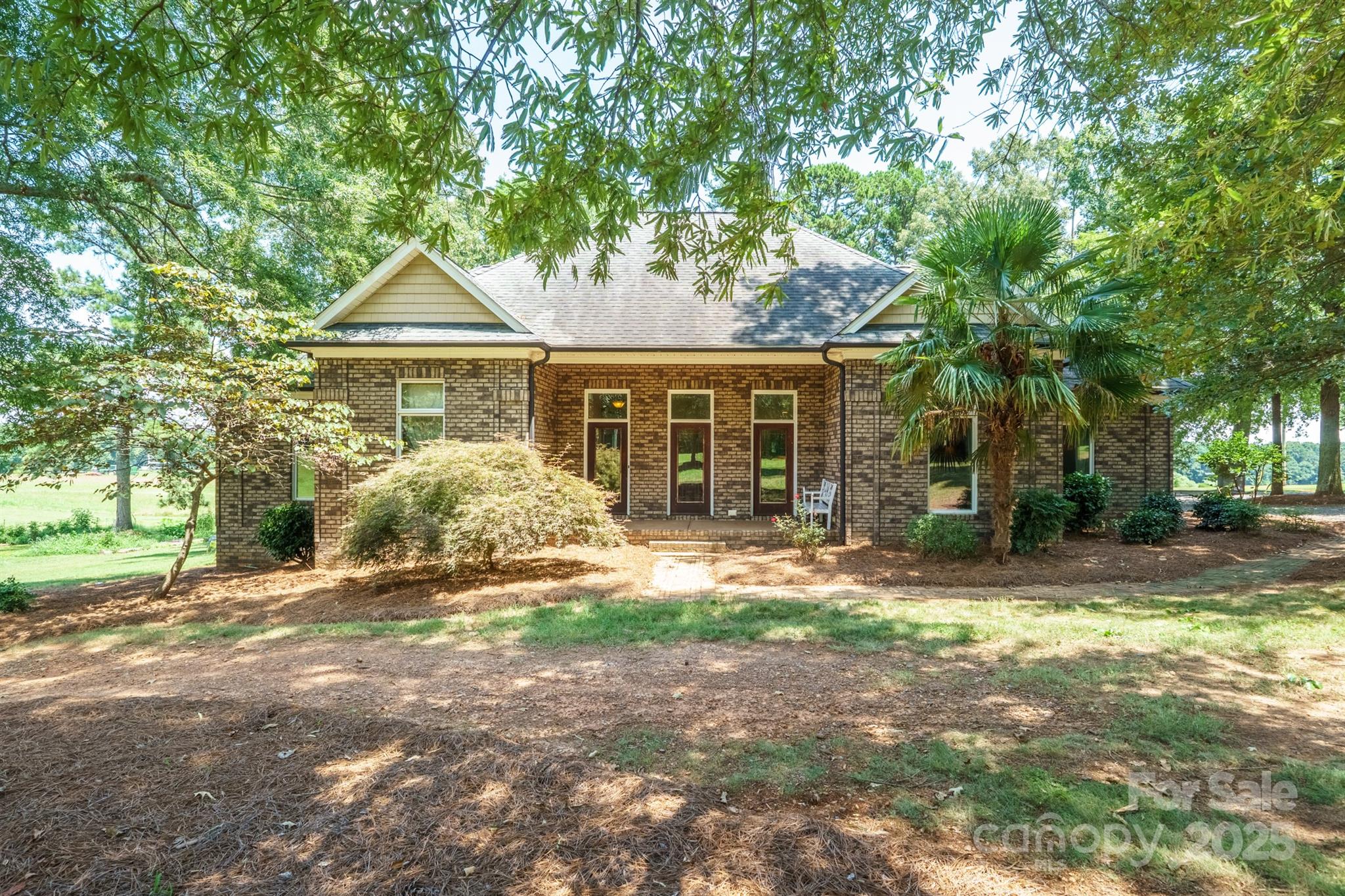 Welcome to this stunning one owner, custom built, full-brick one story home that perfectly blends timeless design with modern comfort. Situated on a 2-acre lot, with no HOA, this property offers space, functionality, privacy, plenty of storage & luxurious details throughout. Step inside to an open-concept layout highlighted by gorgeous hickory hardwood floors in the main living area which create a warm & cohesive feel in every room. The spacious great room features a gas FP, the formal DR adds elegance for special occasions, while the chef’s kitchen impresses with a 5-burner gas stove, granite countertops, & island seating. The Breakfast area or Dining Area, is for your everyday meals. The sunroom is the perfect spot for morning coffee, reading your favorite book or an evening glass of wine. The primary BR is a retreat with a spa-like bathroom boasting a free-standing soaking tub, an expansive walk-in tile shower, double vanities & generous walk-in closet. Two secondary BR's share a full bath. The Laundry room is oversized and offers extra storage with multiple cabinets. Enjoy evenings on the screened porch, gazing into the woods, or on the large back deck with a gas firepit & gas grill. Need space for your car collection? There is an attached 2 -car garage with a large storage closet and storage overhead (may be possible to finish this space) and a detached 2-car Garage that offers ideal space for cars and storage. There's also walk up stairs to more space above. Come take a look at this one of a kind home, you won't be dissapointed~