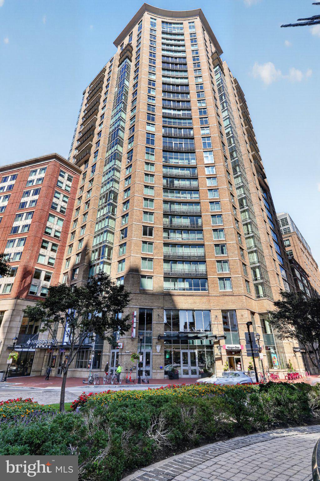 Floor-to-ceiling harbor views, granite counters, and 9-foot ceilings on a high floor in Harbor EastYou'll be captivated the moment you walk in: this 2-bedroom, 2-bathroom condo delivers a luxury, contemporary living experience with breathtaking water views stretching across the Harbor. Perched on a high floor, wall-to-wall windows flood the space with natural light and frame the city and waterfront below.Inside, you'll find a clean, updated interior finished with granite countertops, gleaming hardwood floors, and soaring 9-foot ceilings that give every room an open, airy feel. Stainless steel appliances and an in-unit washer/dryer are installed for your convenience. The open layout makes entertaining or simply relaxing after a long day effortless.As a resident, you'll also enjoy building amenities: an elegant, controlled-access lobby, attentive concierge service, a beautifully landscaped courtyard, and covered garage parking.Location is everything here, and this one delivers. You're steps from the National Aquarium, Historic Ships in Baltimore, and the Reginald F. Lewis Museum, with easy access to Central Avenue and Eastern Avenue putting shopping, dining, and entertainment within easy reach. You're right in the heart of Harbor East.This is city living at its finest. Schedule your private tour today and experience it for yourself!