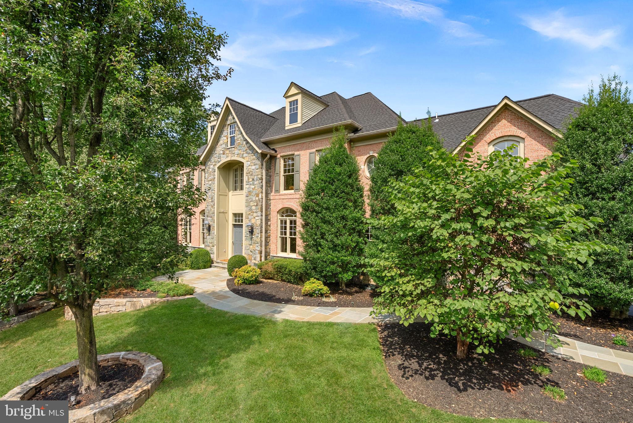COMING THURSDAY! Welcome to one of the most private homes in the sought-after Village of Waxpool community! Privacy and luxury are hard to find together, but this home has both! Set on a rare ¾ acre lot at the end of a quiet cul-de-sac and backing to an expansive tree conservation area, this 5 bedroom, 5.5 bath estate  offers over 8,100 square feet of beautifully finished living space across three levels. Every available builder extension and bump out was added to this home, creating incredible space throughout. The grand two-story foyer welcomes you with a sweeping spiral staircase, beautifully upgraded balusters, an elegant chandelier, and 10-foot ceilings. The soaring family room features floor to ceiling windows, an impressive stone fireplace, rear staircase, and wonderful views of the wooded setting.The enormous chef’s kitchen with newer Thermador refrigerator and freezer (2023), upgraded appliances, brand new quartz countertops, a large breakfast bar, and a convenient light-filled morning room. The formal dining room, with two elegant chandeliers, is perfect for entertaining, while the living room and peaceful conservatory provide beautifully appointed spaces to gather or simply enjoy the serene surroundings. The huge main level office/library is a dream, with floor to ceiling built in bookcases and plenty of room to work, read, or relax.Sophisticated details and custom touches are found throughout the home, including brand new hardwood flooring (2026), luxury LVP (2026) on the lower level, abundant recessed lighting, upgraded decorative lighting (2026), an alarm system with intercom, and speakers throughout the home. All windows have been professionally wrapped in aluminum for added durability and low maintenance. Even the gutters have been upgraded! Brand new 6-inch Bulldog gutters were installed in 2026. Wow!Every secondary bedroom offers the privacy of an en-suite full bath, ceiling fan, and walk in closet. All secondary baths feature upgraded granite and tile. Three zones provide comfortable climate control, while foam insulation in the attic adds to the home’s efficiency. New roof (2024), one HVAC system was replaced in 2026, and the other two were replaced in 2018 and 2019.The primary suite is a luxurious retreat with a dual sided fireplace, two walk in closets, and a spa inspired bath featuring an over-sized frameless three-sided shower with dual shower heads, soaking tub, exquisite upgraded tile, and brand-new quartz countertops. The extra-large second floor laundry room offers exceptional storage and organization, with newer washer and dryer (2021).The walk out lower level is where the fun really begins! There is an impressive theater room with reclining seats and theater components that convey, a great space for a home gym with athletic flooring, and an additional bedroom suite/office with a full bath featuring beautiful travertine tile and a stone shower. And then there is the incredible storage or hobby space underneath the 4-car garage. It is exceptionally large and offers possibilities for all kinds of uses.The outdoor space is just as special. Enjoy the maintenance free Trex deck and expansive, beautifully lighted stone patio with custom stone walls and a dedicated hot tub space with wiring already in place. Surrounded by mature trees and protected conservation land, this is an exquisite backyard where you will truly enjoy the privacy, beauty, and peaceful setting.The location is hard to beat! Walk to Mill Run Elementary and Eagle Ridge Middle School, with Briar Woods High School completing the award-winning school pyramid. Close to major commuter routes, shopping, dining, medical facilities, INOVA Hospital, Dulles International Airport, the Dulles Greenway, Route 28, and Route 7. Minutes to Reservoir Park and Ashburn Rec. Center. The Silver Line Metro is just 2 miles away!Incredible space, an exceptional lot, exquisite finishes, and privacy that is nearly impossible to find. COME SEE!!