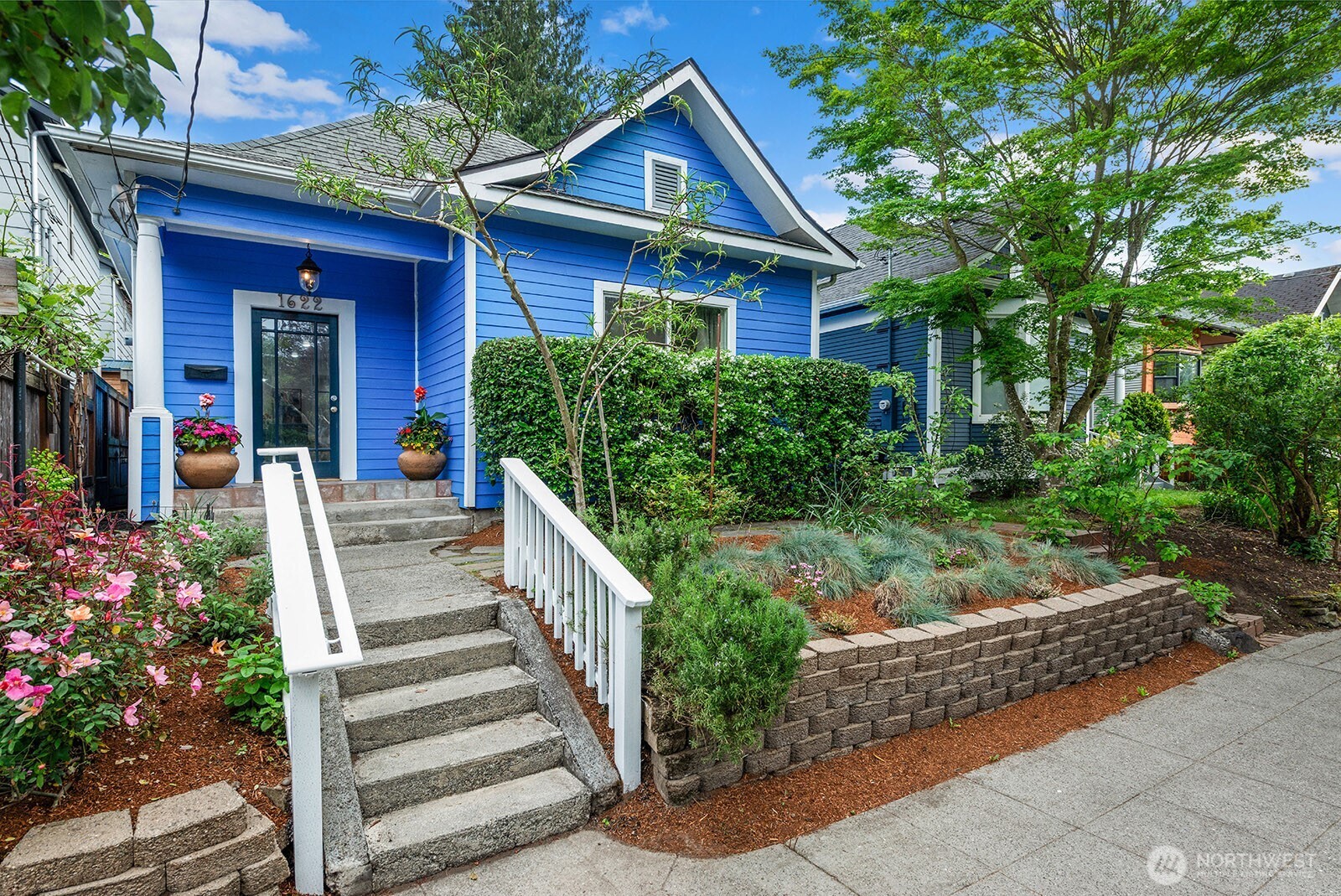 Charming Craftsman has been updated with open floor plan and modern interior. The spacious great room style living/dining room is perfect for entertaining with an adjacent kitchen for meal prep & serving. Kitchen has lots of cabinet space, generous counter space, updated stainless appliances and brand-new range/oven. There are three full size bedrooms, including a roomy primary suite with a full bath, vaulted ceiling, and newer hardwood floors throughout. One of the downstairs bedrooms is currently staged as a large office but could easily accommodate a queen/king bed. Full size washer, dryer and storage come in a double door laundry closet. Go out the back door to your slice of paradise on the fully fenced private back patio where you can enjoy morning coffee in your pj's or evening barbeques with friends. You can admire the fragrance of the flowers and an organic garden, including fruit trees and multiple golden raspberry plants. All of this plus the amazing convenience of the Central District location bordering Capitol Hill and Madison Valley.  Within two blocks of PCC, Safeway, YMCA with pool & gym, plus many other neighborhood amenities. Close to several parks for your morning strolls or walking Rover. Fantastic location for transportation with no car needed. One block to bus stop for 48/8 lines which will take you straight to UW or south to the new Judkins light rail station which will have you in Bellevue in 10 minutes or Redmond in a few more. A commuter's dream!