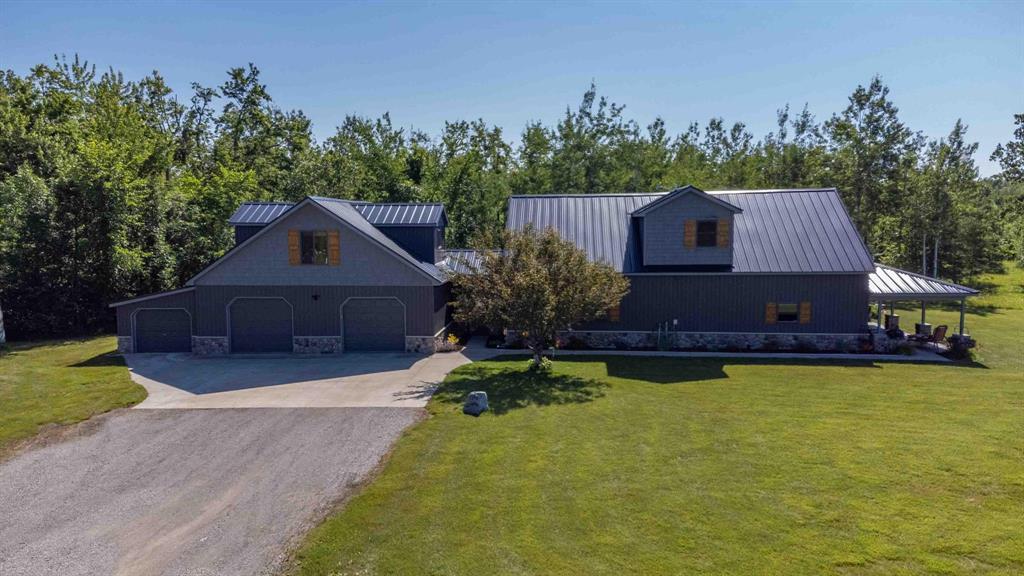 Outdoor Paradise on the Black River - Home with Guest Apartment, Garage, Pole Barn & 40 Acres!Zoned Agricultural nearly 40 acres of pure Northern MI adventure in scenic Cheboygan! Hunt, fish, snowshoe/ski, kayak, boat, ATV, bike, right out your back door. Nestled along the Black River and just minutes from Black Mountain & Black Lake, this is your ideal four-season getaway or forever home. House: 3 spacious bedrooms & 2 full bathrooms, great room with kitchen, dining, living, & peninsula seating, main floor laundry, recreation room, covered porch w/ ceiling fans & stamped concrete patio, new in 2023 windows & siding, new in 2024 steel roof & stone. 2 Rinnai on demand water heaters, A/C. Apartment: Separate entry & utilities 1b/2ba, kitchen, heated garage, pavilion, pole barn, dock, shed