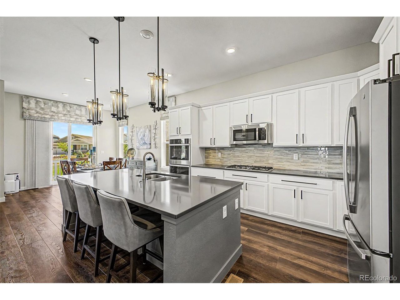 Welcome to model home living in the fantastic & prestigious active adult community of Heritage Todd Creek. This home has been meticulously maintained & decorated beautifully. The custom features abound. The kitchen & family room are perfect for entertaining - an eat-in island & open concept brings all the guests together. Picture yourself enjoying the big game on the TV & guests mingling in the great room, dining area & out on the deck. You'll love filling your custom closet with your belongings.  Enjoy the mountains from the front covered porch. There is luxury vinyl flooring, tile, and upgraded carpet throughout the living areas. The extensive professional landscaping and back patio and fire pit areas are perfect for entertaining - the backyard has an open greenbelt behind it! All window wells have custom well covers. Enjoy the large covered deck complete with fans/lights while relaxing. The garage has been drywalled, textured & painted, It has the finished expoxy floors for ease of cleaning and convenience. This home has over $110k in upgrades!  The full unfinished basement offers plenty of space and a clean canvas for your personal design and completion. Don't miss out on this incredible home in a wonderful community of people in similar life cycles as you. You'll feel the sense of community with all the spectacular events & clubs available to it's residents & a ballroom & restaurant at the clubhouse.
