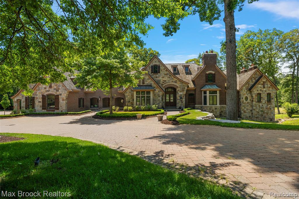 Experience luxury living at this private estate nestled along the Franklin Branch of the Rouge River. Offering over 16,000 square feet of beautifully crafted living space. Nestled on more than 10 serene acres, this property is defined by its tranquil natural surroundings, with the river gracefully winding throughout the grounds. Designed with comfort and grand entertaining in mind, the home features many amenities, including a state-of-the-art theater room and a two-story library, complete with a spiral staircase and exceptional millwork. Intricate moldings and custom woodwork are showcased throughout, reflecting superior craftsmanship at every turn. The inviting three-season room provides a peaceful spot to take in the beauty of the property, while the expansive rear patio spans the length of the home, offering panoramic views of the natural landscape. The expansive lower level is an entertainer’s paradise, boasting a huge great room, a fully equipped second kitchen, a custom bar, a stylish powder room, a game room, and a dedicated craft room. An elevator conveniently services all levels of the home. This one-of-a-kind estate offers a rare combination of privacy, elegance, and resort-style amenities in a truly picturesque setting. Recently renovated with fresh paint, new carpeting, and updated decorative features. The space has undergone a transformation.