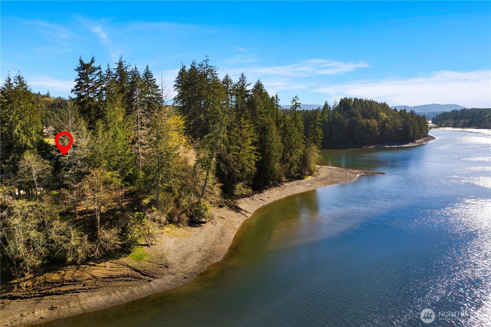 Rare opportunity to own a piece of the Sound. This one-owner, custom daylight basement rambler sits on .73 acres with 71’ of medium-bank waterfront on Little Skookum Inlet. Unlike many coastal homes, this property includes deeded beach and tideland rights, offering you a private gateway to Washington’s pristine marine life.    The main level defines open-concept living, flooded with natural light from vaulted ceilings and skylights. Bamboo hardwoods lead you through the airy Great Room w/ Gas Fireplace, to a chef-inspired kitchen featuring granite tile, stainless appliances. Wake up to shimmering water views in the primary suite, complete with a 5-piece bath, tiled shower, and walk-in closet. Step out onto the wrap-around Trex deck, the ultimate front-row seat for sunrises over the inlet.    The lower level offers incredible flexibility with a second massive living area, wet bar, two additional bedrooms, and a full bath. With its own access to a large cement patio and serene, mature landscaping, this space is primed for ADU potential or multi-generational living.    Fresh interior paint, an oversized 2-car garage, and unrivaled tranquility. Whether you’re harvesting shellfish from your own tidelands or enjoying the view from the deck, this is waterfront living at its finest. Quick access to Arcadia Point Boat Launch, Kennedy Creek Salmon Trail, Walker Park, Salish Cliffs Golf Course, Little Creek Casino and HWY 101.