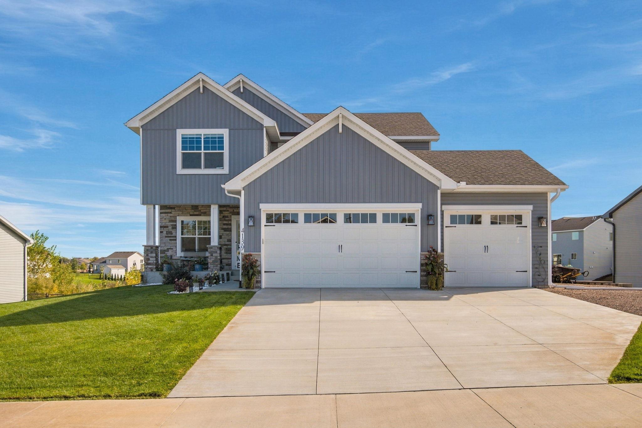 Welcome to this nearly new Monticello home offering modern finishes, a spacious layout, and room for everyone! The upper level features 4 bedrooms on one level, convenient upper-level laundry, and an impressive primary suite complete with a private bath, separate soaking tub and shower, and huge walk-in closet.The open-concept main level is designed for everyday living and entertaining, with a spacious kitchen and dining area that flows seamlessly to the large maintenance-free deck overlooking the fully fenced backyard. A sprinkler system makes lawn care easy. The main level features a den/office space, mud room and 1/2 bath off of the large 3 car garage. Kitchen has walk in pantry Large center Island, and custom cabinets including a large buffet for storage! The finished lower level expands the living space with a huge family and entertainment area, 3/4 bath, and a walkout basement providing direct access to the backyard with a new paver patio for even more outdoor enjoyment. With four bedrooms on the upper level, multiple gathering spaces, a private primary suite, finished walkout lower level, fenced yard, and outdoor entertaining space, this move-in-ready home offers the space and amenities today’s buyers are searching for!