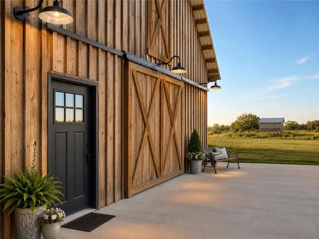 If you've dreamed of country living without the cost of building a new home, this 2 yr old beautiful barn style home on 4.5 acres m/l offers an incredible opportunity!  Located @ 20 miles from Stockton lake, & centrally located only minutes from Sheldon, Nevada, Lamar, & El Dorado. Close enough to town for convenience, yet space for chickens, horses, or whatever you desire.  Never lived in as a residence, this was originally built for entertaining & much of the hard work has already been completed for you to make this your home. The quality finishes are amazing! The open floor design welcomes family/friends to gather while enjoying the excellent craftsmanship. From the stunning tongue & groove wood ceilings & exposed timber beams to the spacious kitchen with quality cabinetry, concrete countertop, farm style apron sink, stainless appliances & a rolling island for flexibility. On the main floor, 1 bedroom with walk in closet is present & another non-conforming bonus room is ready to be finished at your own pace. Two adjacent 1/2 baths create an easy opportunity to combine the space into a comfortable full bath by adding a shower, allowing you to finish it exactly the way you want.  The open living/family area allows the space to be flexible. On a beautiful day, open the barn door and flow out onto the concrete patio for family/friends to mingle, or seal it up forever. Upstairs you'll find a, one of a kind, great room/loft which allows for nearly 1200 square feet of extra living space. (see layout design ideas in pictures) Large enough for a lovely primary suite as well as an impressive family room. The carpeted space has beautiful natural light, vaulted ceiling & a barn cupola sky light adding a unique wow factor! Efficient heating & air mini splits are in place for year around comfort upstairs & down. Venture outdoors & relax on the covered back patio to watch the perfect sunsets, or stroll across the charming bridge at the pond & love your new life in this home.