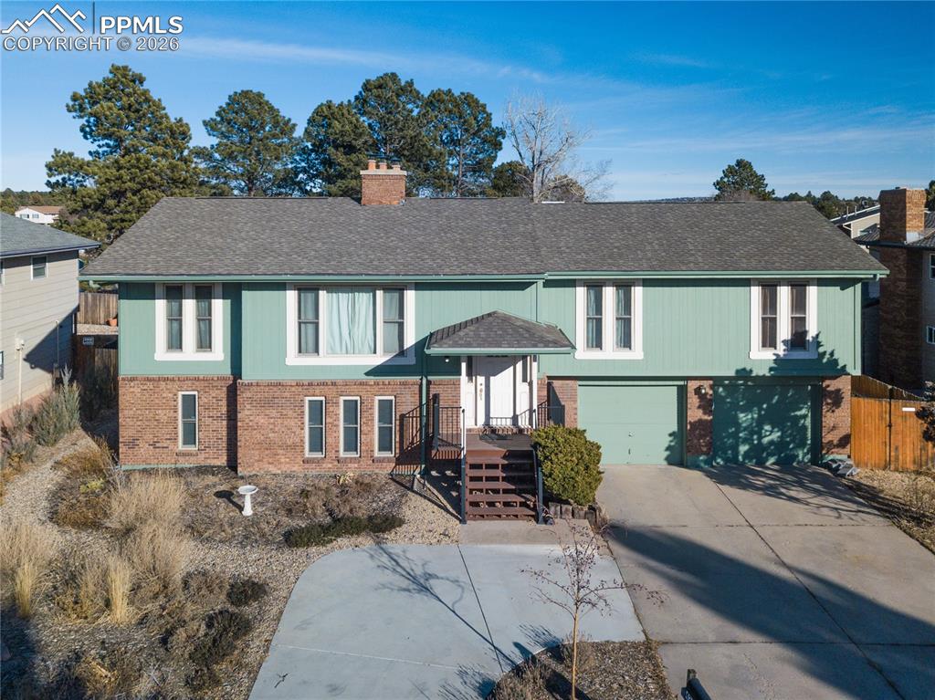 Make this summer unforgettable with a backyard designed for real living and effortless entertaining. At the heart of this Rockrimmon property is a seldom-found heated in-ground pool paired with a spa, creating a true private retreat just steps from your door. Fire up the grill beneath the expansive covered deck, gather around the brand-new fire pit in the evenings, or relax poolside with your favorite drink while enjoying the privacy of your own resort-style setting. The outdoor space has been further enhanced with a new deck and a new storage shed, giving you both style and functionality. The pool area is fully fenced and equipped with newer energy-efficient mechanicals, a self-cleaning system, and updated color-changing lighting for both the pool and hot tub. The home itself sits against open space and nearby walking trails, blending outdoor recreation with neighborhood convenience. Inside, you’re welcomed by custom-fabricated metal stair rails and warm wood flooring throughout the main living spaces. The kitchen has been refreshed with updated hardware, backsplash, and black stainless-steel appliances. Downstairs, the walk-out basement offers additional flexibility with updated finishes, custom tile flooring, a wet bar, a remodeled bathroom, and a separate exterior entrance—ideal for guests or multi-use living. Additional improvements include double-hung windows (2007), a 200-amp electrical panel (2020), and interior paint (2021). An oversized two-car garage provides ample storage and workspace. Homes with private pools are exceptionally rare in Colorado Springs—far fewer than 1%—making this property a standout opportunity. This isn’t just a home—it’s where summer lives, and every weekend feels like a vacation. If you’ve been waiting for the one that truly has it all—location, updates, and a backyard everyone will talk about—this is it. Every effort has been made to ensure the accuracy of the information provided; please independently verify the information.