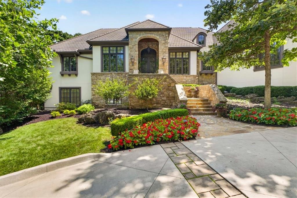 RARE opportunity to own a gorgeous Reverse 1.5 with HUGE 3/4 acre walk-out lot on hole 17 in Loch Lloyd! Scott Bickford has designed an additional 2 car garage that could fit on this lot with a pool. This house would cost 4 MILLION+ to reproduce...Here you are on one of the prime finishing holes of the golf course with great PRIVACY and spectacular views. The home has been meticulously maintained and includes a newer driveway, lighting, oversized garage, remodeled Chef’s kitchen with top of the line appliances, large island, updated Master bath with heated floors, steam shower and the most unbelievable primary closet you have ever seen! Lower level has a huge bar for entertaining family and friends that includes an ice maker, refrigerated drawers, dishwasher and for the wine connoisseur, don't miss the 1,000+/- bottle temperature controlled wine room and tasting area. 2 bedrooms are located on the lower level with ensuite baths. (The 4th bedroom that was converted to the fabulous closet off the primary bedroom could be converted back to a 4th bedroom or another bedroom could be fashioned in the lower level.) Home has multiple outdoor entertainment areas including an enclosed lanai accessible from the Primary bedroom and Living Room, covered patio, outdoor built in grill and outdoor speakers. 130k in electronics, security, commercial generator, surround sound and cameras. New Loch Lloyd amenities are completed and include a new pool with swim up bar, pickleball, exercise facility and more!