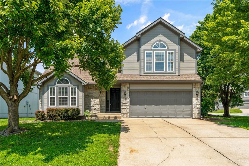 This home is nestled in one of Missouri's most beloved lake communities—Raintree Lake. This stunning home combines warmth, character, and generous living spaces with a location that offers an unmatched lifestyle.From the moment you step inside, you'll be captivated by the beautiful arched windows that flood the home with natural light, highlighting the rich hardwood floors and natural wood accents throughout. Fresh interior paint and brand-new carpet with upgraded padding create a crisp, move-in-ready feel, allowing you to enjoy the home from day one.The kitchen/dining room opens to living areas and is large enough to comfortably accommodate 15+ guest-perfect for holiday gatherings, celebrations, and unforgettable dinners with family and friends. The vaulted great room, anchored by a cozy fireplace, provides an ideal setting for everyday living and entertaining alike. The private primary suite offers a relaxing retreat complete with a walk-in closet, dual vanities, whirlpool tub, and separate shower. The finished lower level is designed for entertaining, featuring built-in surround sound speakers, a wet bar, a fourth bedroom, a full bath, and flexible living space ideal for movie nights, game days, or hosting guests. Need extra space? The sub-basement provides abundant storage and room for a home gym, workshop, or hobby area.Outside, enjoy the peace and beauty of a neighborhood known not only for its lake lifestyle but also for its sense of community. This home is situated at the entrance to a cul-de-sac. Residents love the amazing neighbors, scenic surroundings, and access to Raintree Lake's exceptional amenities, including boating, fishing, swimming pools, tennis courts, walking trails, playgrounds, and clubhouse facilities. Located in the highly sought-after school district of Lee's Summit, this home offers the lifestyle that makes Raintree Lake one of Missouri's favorite communities and is ready for its next owners to make lasting memories.