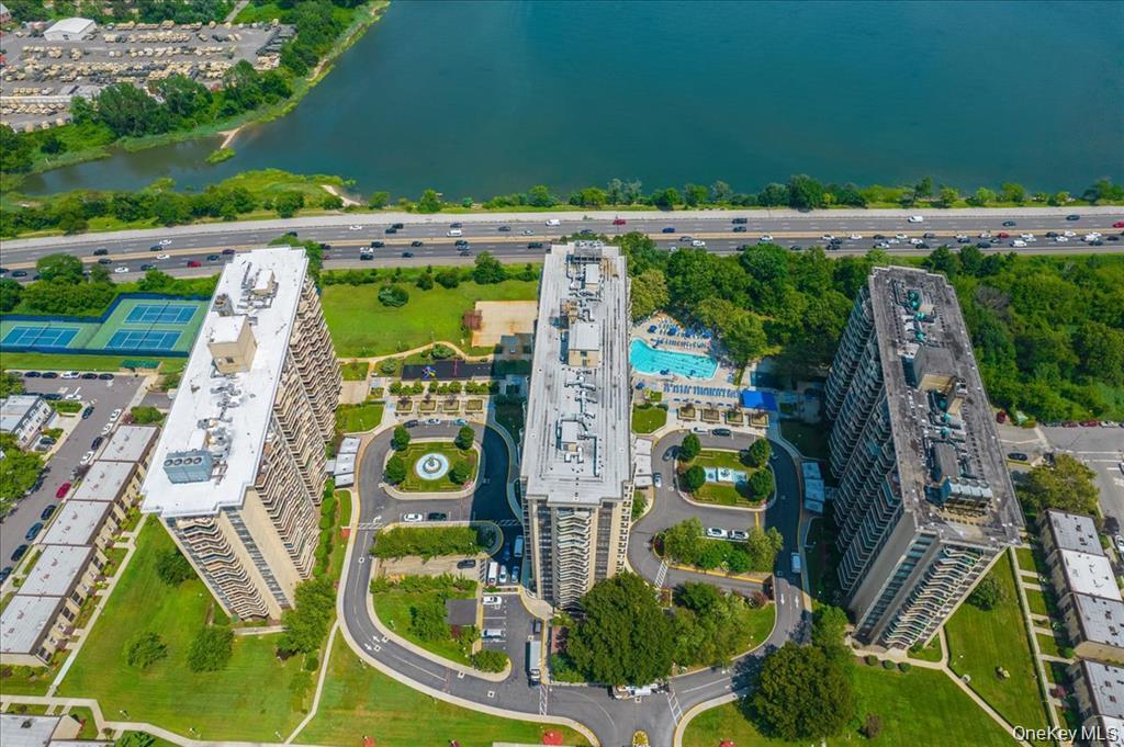 Experience effortless luxury in this beautifully renovated 3-BR, 2-BA end unit positioned directly on the water at the prestigious, pet-friendly Americana at Towers at Waters Edge. Perfect for downsizers seeking a lock-and-leave lifestyle, this rare corner residence boasts panoramic water views from oversized windows, custom built-ins, and closets galore. Enjoy outdoor living with two private terraces, including an exclusive primary suite balcony with direct water views. The home features a renovated chef’s kitchen with quartz counters and premium stainless appliances. The expansive primary retreat offers an ensuite bath, all three bedrooms have panoramic water views! Indulge in a full-service lifestyle: 24-hour doorman, heated pool, fitness center, tennis/pickleball, BBQ area, and an on-site deli, salon, and dry cleaners. Minutes to Bay Terrace Shopping Center and a 22-minute express train to Manhattan. Two Garage Levels offering guaranteed parking.
