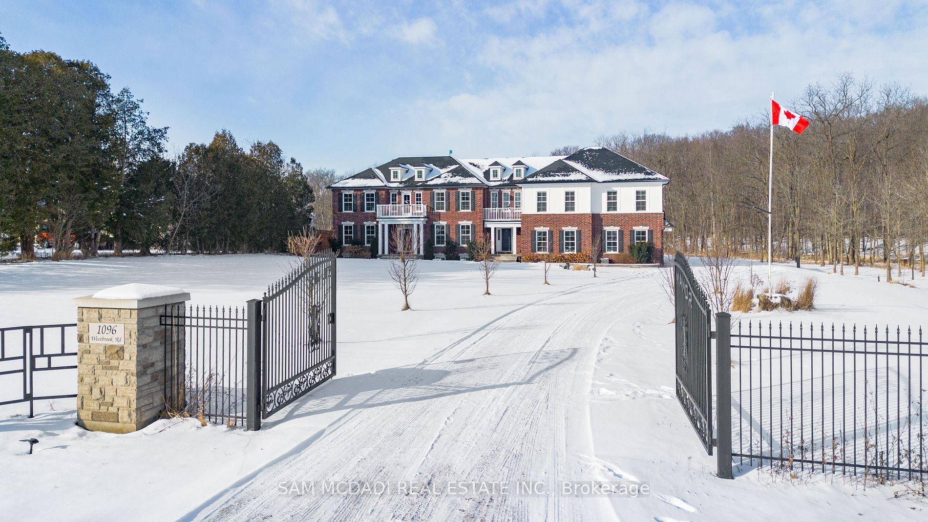 Welcome to 1096 Westbrook Rd! Nestled on a sprawling 10-acre property with a 943.58 ft. deep lot, this multi-generational home is designed for discerning families and buyers seeking versatility, and privacy. With an impressive setback behind its gated entrance, this exceptional property boasts approximately 6,937 sq. ft. of thoughtfully designed living space. The main level captivates with its rich hardwood floors, glistening pot lights, and effortless flow from room-to-room; including a den that easily converts into a bedroom. The combined kitchen and breakfast area is fully equipped with custom-built appliances, including a double oven, dishwasher, and stove and a walk-out to a patio. Step out to the screened patio, where a wood-burning fireplace creates a cozy atmosphere as you take in serene views of the expansive backyard; complete with a playground, perfect for children and family.The upper level is masterfully divided into two wings, offering functionality. The left wing features four spacious bedrooms, including a modern Owners suite with a 4-piece ensuite showcasing a freestanding tub and a shower with a built-in seating. A private balcony extends the suite, offering a peaceful space to unwind and enjoy the tranquil surroundings. The right wing serves as a self-contained living space, ideal for extended family or guests, with three bedrooms, a kitchen, a family room, and a sunroom warmed by a fireplace, which opens onto another private balcony. An elevator effortlessly connects all levels, including the fully finished basement. Here, you'll find two additional bedrooms, a large open-concept recreation area, and a dedicated laundry space, offering endless possibilities for additional income, and entertaining. With its outstanding layout, modern upgrades, and private, picturesque setting, this is more than just a home its an opportunity to create lasting memories. Don't miss out on this exceptional property! **EXTRAS** Boasts over $200K in upgrades, including