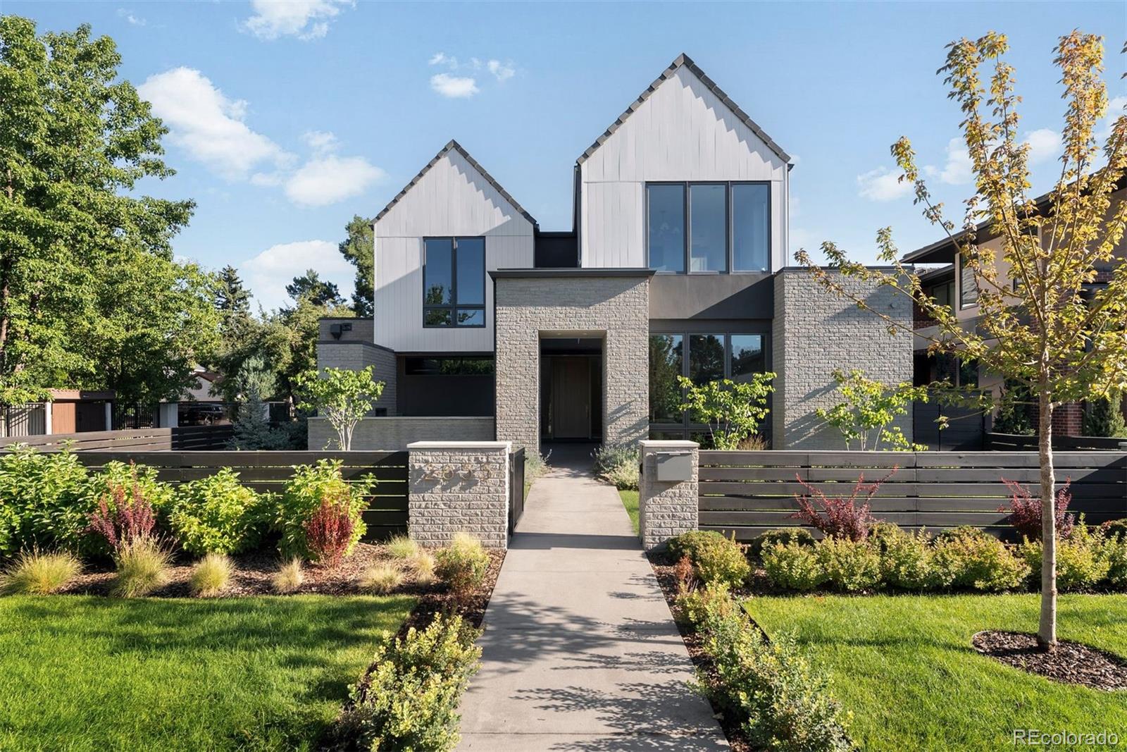 In one of Denver’s most exclusive enclaves, this newly built estate rises as a statement of architectural artistry and modern indulgence. Spanning more than 8,500 square feet, it is more than a home; it is a private sanctuary where elegance, comfort, and prestige converge at the highest level. The kitchen is a true showpiece, designed as both a chef’s dream and an entertainer’s stage. Professional-grade Thermador appliances complement an Matarazzo Marble waterfall island and full backsplash, while a nearly 100-bottle wine column and hand-finished White Dove oak cabinetry elevate every culinary moment. The formal dining room flows gracefully to the covered patio and lush backyard, while the great room commands attention with a soaring Marble fireplace and Nano doors that dissolve the boundary between indoors and out, creating a seamless resort-like retreat. The west wing primary suite defines sophistication, with a private balcony overlooking the grounds, a fireplace for intimate evenings, and a spa-inspired bath with dual vanities, sculptural freestanding tub, oversized shower, and a couture-level custom closet. A luminous loft separates this haven from three additional en-suite bedrooms, ensuring privacy and comfort for family and guests alike. The lower level transforms leisure into an art form, with a refined lounge and wet bar, a climate-controlled wine room, a glass-enclosed fitness studio, a state-of-the-art golf simulator, and a secluded guest suite that offers the ultimate in comfort. Set on a manicured 10,167 square foot lot, the estate is enhanced by an oversized three-car garage and professional landscaping. Just moments from Cherry Creek’s designer boutiques, acclaimed dining, galleries, and cultural experiences, this address combines the best of Denver living with the rarity of brand-new construction. 2655 E. Cedar Avenue is not simply a residence; it is a legacy estate crafted for those who expect nothing less than extraordinary.