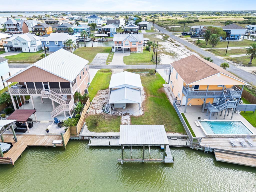 Fantastic opportunity to own a canal-front lot with a storage shed/carport and boat lift offering easy access to Copano Bay&mdash;one of the best fishing and boating spots on the Texas Coast! Use for your weekend park and to  build your dream home or purchase together with the adjacent property at 102 Ball St (MLS#R149024) for the ultimate waterfront setup with home and pool combined. This lot is currently part of the same CAD# as the home next door; if sold separately, a split application will be required to establish a new CAD#. Seller is offering incentives for buyers who purchase both properties together. Please note: Property taxes are estimated based on the amount for Lots 1 & 2 combined. There is no individual water meter at this time&mdash;water currently comes from the house at 102 Ball St. Buyer will be responsible for connecting to public water and electricity and installing a private septic system. Create your own coastal retreat in a peaceful canal community with quick access to the bays, beaches, and all the fun Rockport has to offer! Seller/owner is a licensed Realtor in Texas