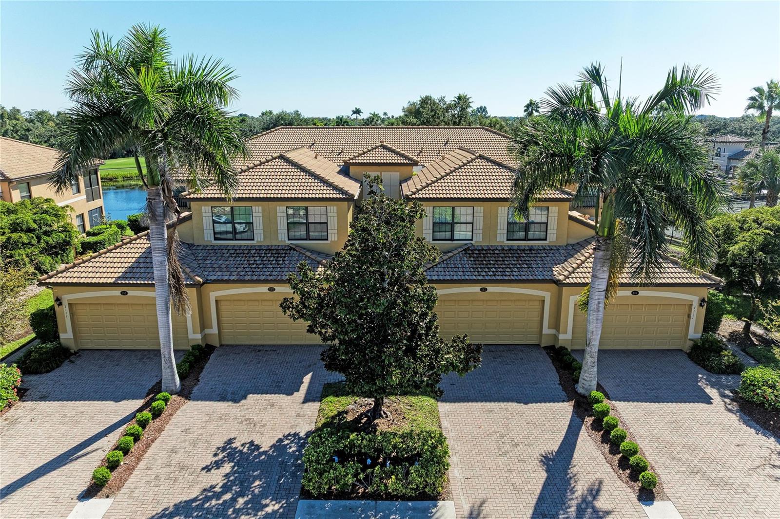 Discover an exceptional opportunity to own one of the rarely available OPEN FLOOR PLAN SECOND FLOOR COACH HOMES in THE GATED RESORT COMMUNITY of River Strand Golf & Country Club!  From the moment you enter, the difference is unmistakable. One of the select Coach Homes designed by Lennar without a wall separating the kitchen from the great room, this residence offers a wonderful OPEN CONCEPT LIVING experience with effortless flow and uninterrupted sightlines. The kitchen, complete with a breakfast bar, opens beautifully to the spacious great room, creating an ideal setting for both intimate evenings and elegant entertaining.With more than 2,100 square feet of beautifully proportioned living space AND OFFERED FURNISHED, this residence offers the scale and comfort of a single-family home with the ease of maintenance-free living. An expansive screened lanai extends the living space outdoors, where BREATHTAKING GOLF AND WATER VIEWS create a serene backdrop for morning coffee, sunset cocktails, or entertaining guests.The location is equally impressive. Situated just MINUTES FROM THE CLUBHOUSE, you are effortlessly close to championship golf, tennis, dining, the tiki bar, and evening entertainment. The home’s position on the right side of the street is an added advantage, helping minimize the intensity of the afternoon sun—an often overlooked benefit that discerning buyers often appreciate.The primary suite is a luxurious private retreat, generously sized and thoughtfully designed with two walk-in closets, a spacious ensuite bath with dual vanities, and sliding glass doors opening directly to the lanai. Two generously proportioned guest bedrooms each feature their own walk-in closet and share a beautifully appointed guest bath, providing comfort and privacy for family and guests.A two-car tandem garage with epoxy flooring provides exceptional flexibility, with ample room for vehicles, a golf cart, and additional storage. Every element of this home has been designed to make Florida living effortless.And beyond your front door lies the exceptional lifestyle of River Strand. This sought-after community features 27 holes of pristine golf winding throughout the community, along with a RECENTLY RENOVATED CLUBHOUSE WITH RESTAURANT, grille room, tiki bar, resort-style pools and spas, fitness centers, tennis and pickleball courts, and an impressive calendar of social activities and entertainment.From fitness classes and trivia nights to wine dinners, bingo, live entertainment, and leisurely afternoons by the pool, River Strand offers an extraordinary blend of recreation, relaxation, and connection.Perfectly positioned just minutes from I-75, this residence places you within easy reach of airports, world-class dining, shopping, entertainment, and Florida’s beautiful Gulf Coast. The nearby Marketplace continues to expand its collection of shops and restaurants, adding to the convenience of this enviable location.This home offers a rare combination of elegant open living, spectacular views, exceptional amenities, and a coveted location, all within one of River Strand’s most desirable settings.Come experience the refined Florida lifestyle in River Strand at it's best..... you may  never want to leave.