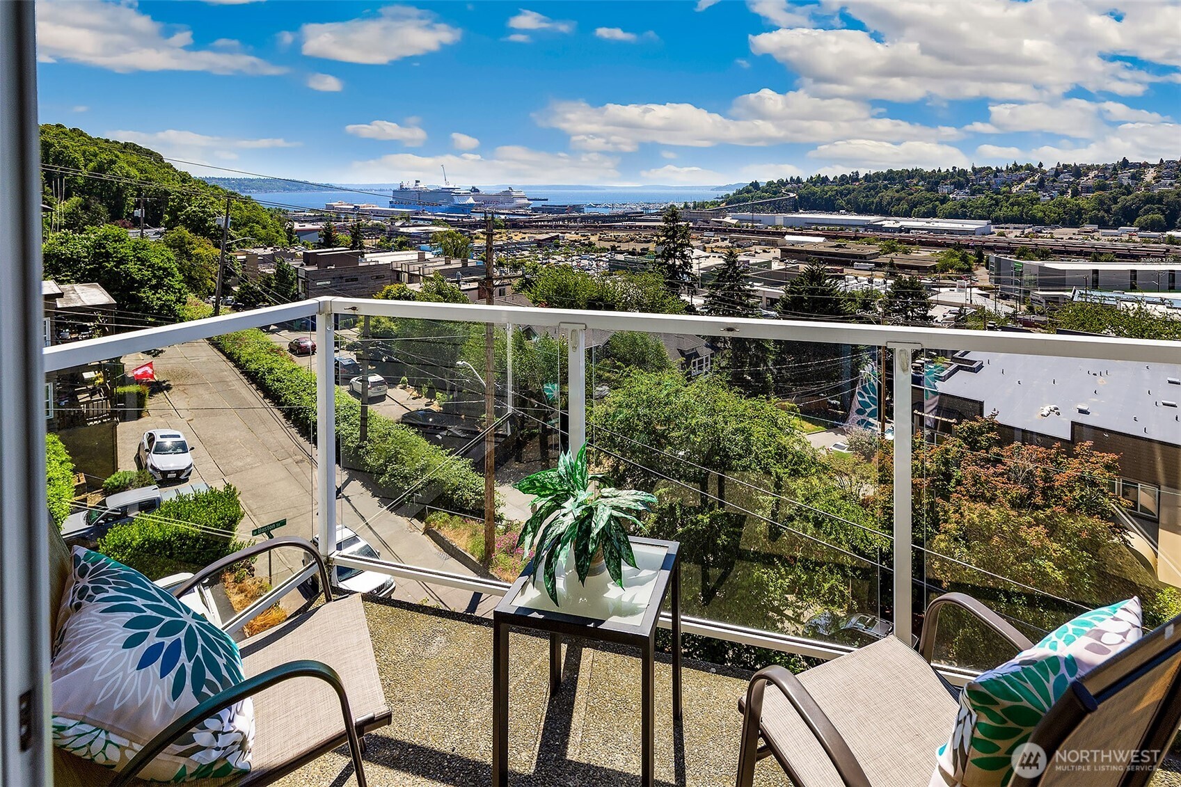 Enjoy stunning sunsets and cruise ship views from this lovely condo! This 2-bed, condo features a spacious 1,077 sq ft layout with a private lanai perfect for entertaining. The inviting living room features a cozy wood fireplace and wet bar. Newly updated with fresh carpet and paint, the condo also features a formal dining area and a kitchen with an eating bar, plenty of cabinet space, and a new dishwasher. Washer/dryer in unit, one car garage parking and storage locker. Secure your spot in this serene, well-managed building with no rental cap. Just moments from Queen Anne's eateries, Whole Foods, Interbay Golf Center and Downtown!