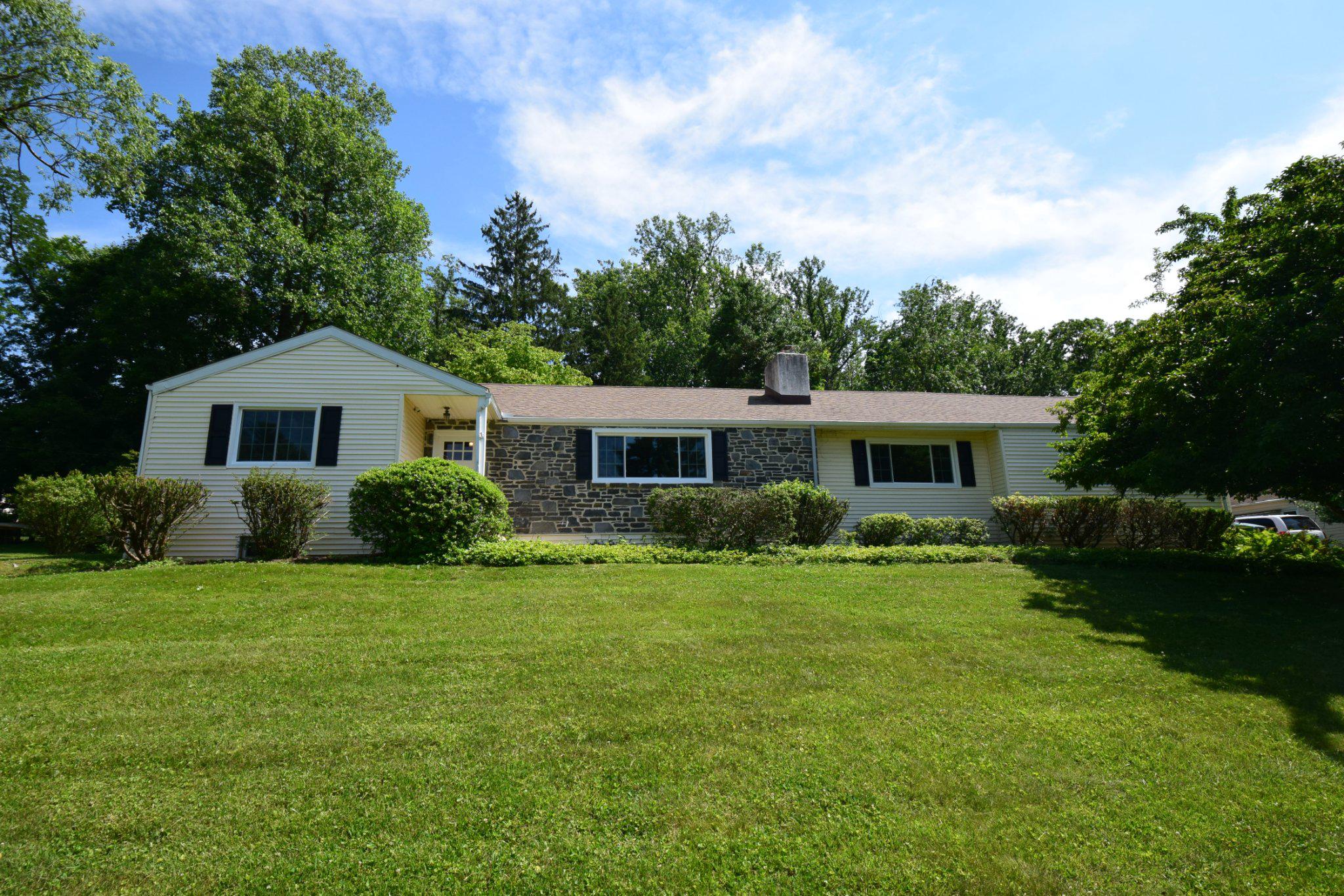 Spacious stone Colonial has 4 bedrooms, 3 full bathrooms, and a 2-car garage, ideally situated on a quiet street just moments from the TE Middle and High schools, and Hillside Elementary. Step outside to a covered flagstone patio overlooking a private, level backyard—perfect for entertaining, relaxing, or play. A storage shed tucked into the rear corner of the property provides additional space for tools and outdoor equipment. Inside, you'll find beautiful hardwood floors throughout the foyer, hallway, dining room, living room, and a bedroom. Inviting Dining room opens to Living room which features a classic stone fireplace, creating a warm and comfortable gathering with scenic views of VF Mountain. The expansive, dry basement nearly doubles the home's usable living area and offers exceptional flexibility. It includes a finished paneled room, a full bathroom, laundry room, craft room, utility area, and abundant storage, making it ideal for hobbies, recreation, or additional living space. Recent updates make this home truly move-in ready, including refreshed bathrooms, freshly painted interiors, new carpeting, and newly replaced front-facing windows. Major mechanical improvements provide added peace of mind, including a new roof installed in 2020 with gutter leaf guards, an attic HVAC system replaced in 2012, and a recently installed electric pannel. To top it off, the seller is including a one-year home warranty, offering added confidence for the new homeowner.