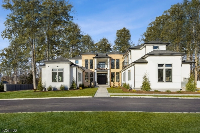 Nestled on almost an acre, this NEW and CUSTOM luxury estate is the epitome of luxury living. Completed in 2025, this breathtaking masterpiece offers 15,000 square feet of exquisitely designed living space, featuring 17 rooms, including 7 ensuite bedrooms and 8.1 bathrooms. The exterior impresses with its seamless blend of stucco and aluminum planks, oversized Pella Lifestyle windows and multiple balconies. The property includes a circular driveway, a three-car garage with epoxy floors and custom Mahogany doors, and beautifully landscaped grounds, complete with a covered paver patio and outdoor kitchen. Inside, a soaring 22-foot foyer welcomes you. You are sure to be impressed by the 11-foot ceilings, 5" white oak floors, and a state-of-the-art Chef's kitchen with Calacatta quartz countertops, custom cabinetry, top-of-the-line GE Monogram appliances, large center island, and "hidden" walk-in pantry. The primary suite offers a private terrace with a spa-like bath & custom walk-in closets. All bedrooms include ensuite baths and WIC's. The fully finished walkout basement is designed for entertainment and relaxation, boasting a massive recreation room with wet bar, home theater, exercise room and sauna. Additional features include a Generac 40kW whole-house generator, 5-zone HVAC, NEST thermostats, LED lighting, sprinklers and a huge yard. With its breathtaking design, high-end finishes, this one-of-a-kind estate invites you to experience a life of refined luxury beyond compare.