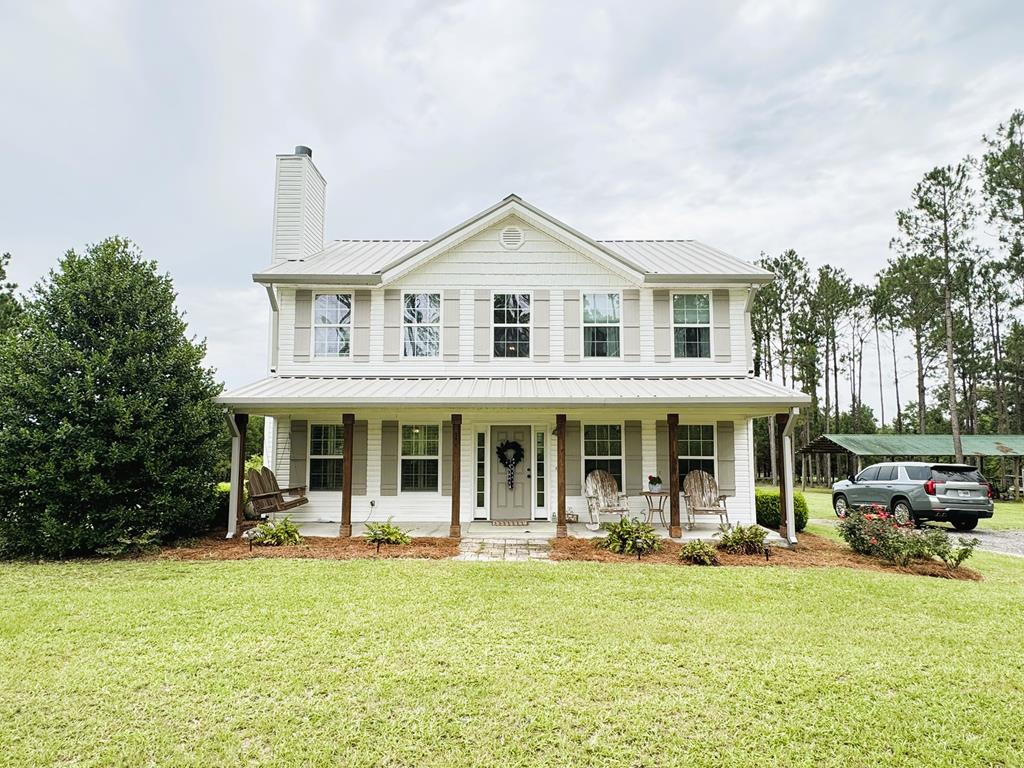 Tucked away on 5 beautiful acres surrounded by mature pines and stately oak trees, this charming two-story home offers a setting reminiscent of classic plantation grounds—peaceful, private, and picturesque. Inside, you'll find a well-designed layout featuring 3 bedrooms and 2.5 baths, with all bedrooms conveniently located upstairs for added privacy. The main level offers a welcoming flow, highlighted by a spacious kitchen with a large island—perfect for meal prep, entertaining, or gathering with family. The kitchen opens seamlessly into a bright breakfast area, creating a warm and functional everyday living space. Step outside to the covered back porch, where you'll want to spend your mornings enjoying coffee in the soft sunlight or unwind in the afternoons shaded by the surrounding trees. The natural beauty and tranquility of the property make this outdoor space truly special. If you've been looking for a home that combines charm, privacy, and a stunning natural setting—this is one you need to experience in person.