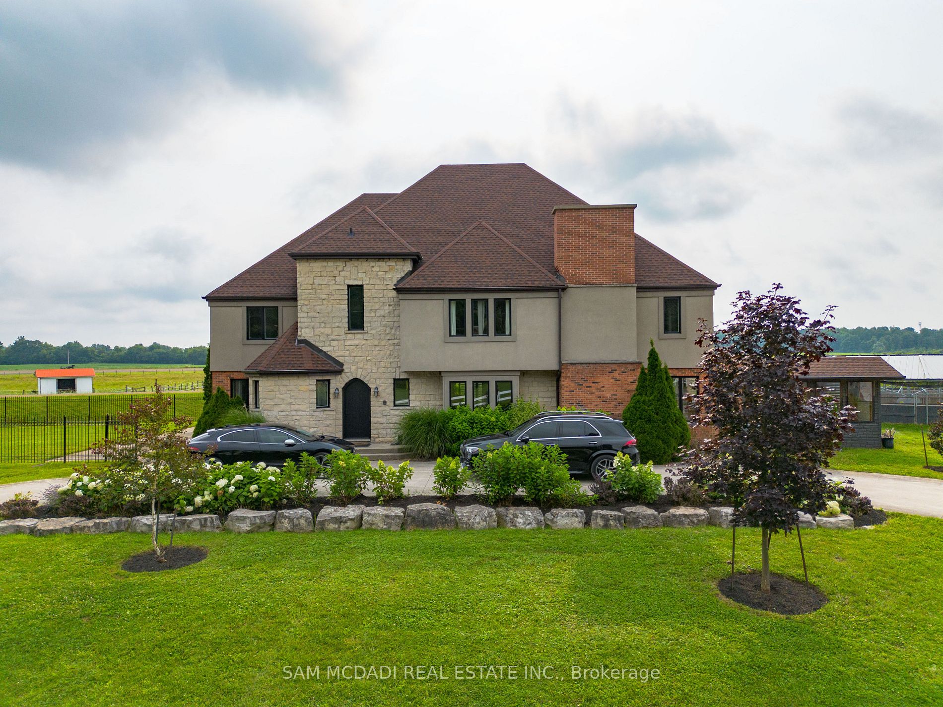 Discover a remarkable 98-acre estate offering unparalleled versatility, luxury, and opportunity. At its core stands a newly renovated, custom-built 2-story home with a spacious loft, encompassing over 5,500 square feet. Boasting 6 bedrooms and 7 bathrooms, this residence harmoniously combines grand entertaining spaces with everyday comfort.The fully finished, walkout basement is a showstopper, designed for entertaining or as an in-law suite. It features high-end, floor-to-ceiling upgrades, a spacious living area, a kitchenette, a full bathroom, and private access, making it a perfect self-contained space for extended family or guests. Whether hosting gatherings or providing a comfortable retreat for loved ones, this basement is as functional as it is luxurious.The estate is a haven of natural beauty, with panoramic views of rolling farmland, a serene pond, woodlands, lush grasslands, and scenic trails perfect for exploration on foot or horseback.Equipped for excellence, the property features a premier training facility designed and built by the renowned Coon Brothers, with two professionally crafted Standardbred training tracksa 5/8-mile track and a 1/3-mile track. The facility includes 9 barns, 175 stalls, and 31 paddocks, offering exceptional income potential and flexibility under P8, P7, and A2 zoning.With 45,000+ square feet of indoor space, the barns and additional buildings provide unmatched versatility and can be tailored for a variety of uses, including office spaces, storage, automotive workshops, or rental dwellings. This unique functionality makes the estate an extraordinary investment opportunity for various business ventures.This exceptional property offers a rare blend of luxury, natural beauty, and business potential. Don't miss your chance to own this one-of-a-kind estate, where the possibilities are truly endless.