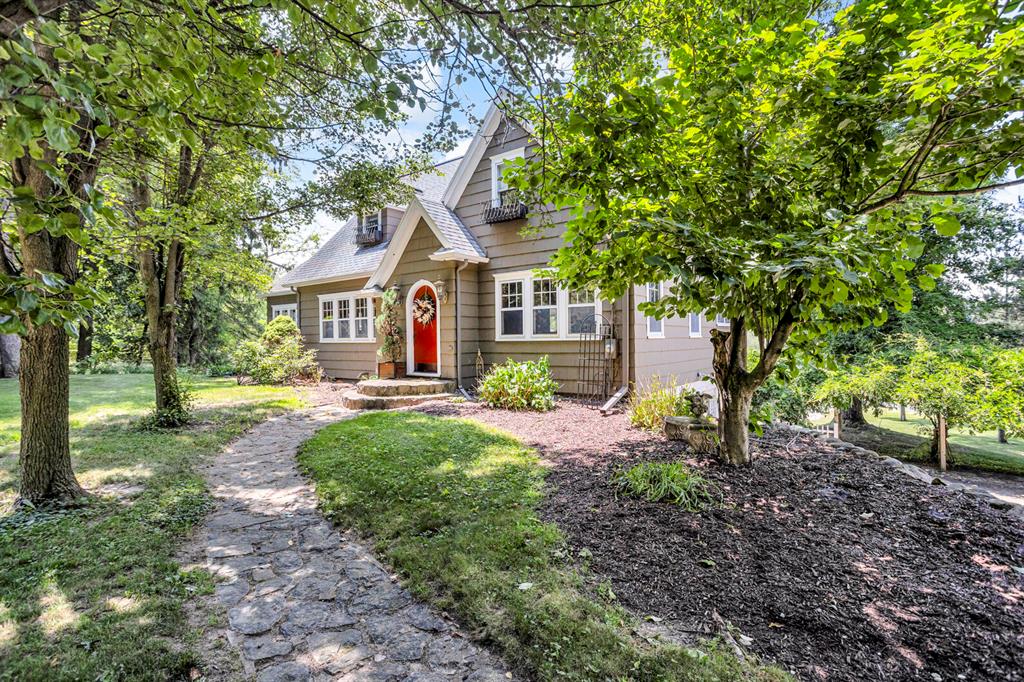 Incredible opportunity to have it all--10 acres, a private pond, and a stunning, one-of-a-kind home just minutes from town! This character-filled retreat features a dreamy upper-level suite with gas fireplace, balcony, walk-in closet, and luxurious 18'x10' bath with laundry. The spacious kitchen includes a large island, dining area, and porch with sunset views. Enjoy a formal dining room with hardwood floors, a  gorgeous sunroom, and a living room with rich wood detail and fieldstone fireplace. The finished walkout level offers a 3rd bedroom, gym/office, new full bath, half bath, cozy family room with bar, kitchenette, and fireplace!