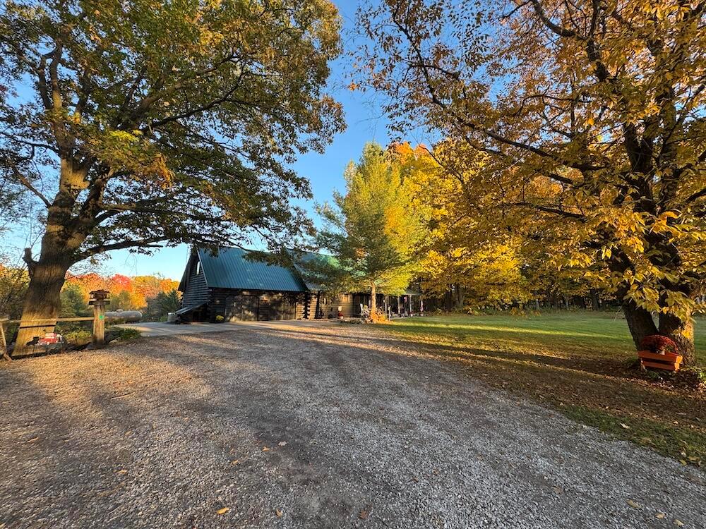 Tucked away at the end of a long, private driveway, this magnificent log home offers the perfect blend of rustic elegance and modern comfort. With 2,733 sq. ft. on the main levels and a fully finished walkout basement, you'll enjoy nearly 4,400 sq. ft. of luxurious living space, including four spacious bedrooms and three full bathrooms.Step inside to a grand great room where soaring ceilings, exposed beams, and a floor-to-ceiling stone fireplace create an unforgettable first impression. The gourmet kitchen is a chef's dream, featuring premium appliances, a large walk-in pantry, and seamless flow into the expansive formal dining room, where picture windows frame panoramic countryside views in every direction.The home's thoughtful layout extends to a bonus room and loft, perfect for a home office, gym, or additional lounge space. A large rear deck and covered front porch invite you to relax outdoors.Enjoy breathtaking sunrises over the pond and spectacular sunsets across the property.
For HVAC, the boiler system was recently replaced and is all new. The extensive mini-split system provides AC to all levels, and a standby generator provides peace of mind year-round.
Outdoors, this property is a true paradise. The 47.62-acre estate features a harmonious mix of rolling timber, open meadows, and fenced pastureland, ideal for horses or livestock. A 30x40 horse barn with four stalls, dual lean-tos, and a newly fenced pasture makes it a dream setup for the horse or animal lover. Additional machine and garden sheds provide plenty of storage for tools and equipment.
Explore the property's extensive trail system, winding beneath towering maple trees and around the scenic pond, a haven for wildlife and a photographer's dream. With a strong history of excellent hunting, established food plots, and blinds already in place, this property is ready for the outdoor enthusiast. Deer, turkey, bear, and small game are abundant.
From its stunning craftsmanship to its serene setting and turnkey amenities, this one-of-a-kind log home off