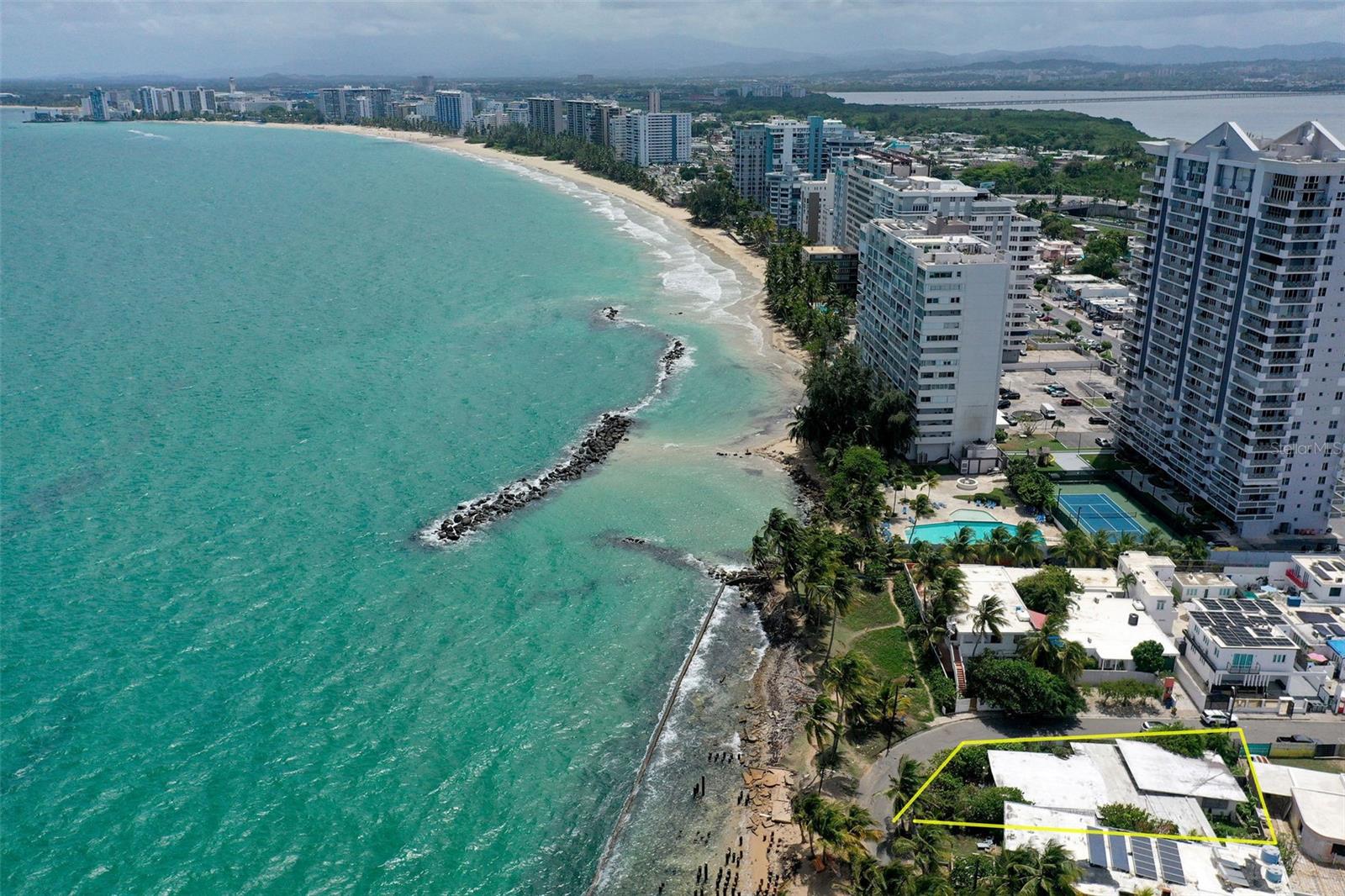 Oceanfront Renovation Opportunity in Punta Las Marías with permits!A rare opportunity to create an extraordinary oceanfront residence in Punta Las Marías, one of San Juan’s most desirable coastal neighborhoods. Situated on a generous 778-square-meter corner lot within a gated area, this single-family property enjoys a true beachfront setting with the Atlantic Ocean directly beyond your doorstep.The existing home features 3 bedrooms, 2.5 bathrooms, approximately 2,123 sq. ft. of covered space, plus a terrace. The real opportunity, however, lies in its potential for transformation. Approved renovation plans with permits are already in place, providing a head start toward creating the remarkable coastal home illustrated in the architectural renderings. The large lot and oceanfront position provide an exceptional canvas to combine contemporary design, outdoor living, and uninterrupted connection to the sea.Ideally positioned next to Isla Verde Beach, the property offers the privacy of a gated residential setting while remaining minutes from San Juan’s top private schools, the airport, restaurants, Condado, and Isla Verde. For a buyer looking to renovate and create a distinctive home tailored to their lifestyle, this is a unique opportunity to build something truly special directly on the ocean.