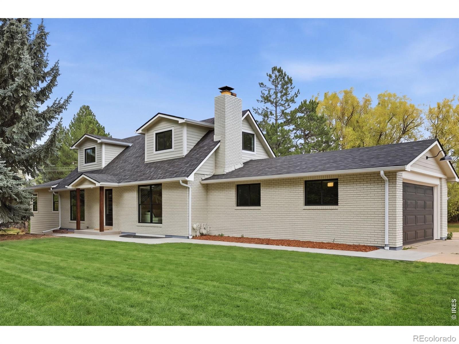 Tucked behind a gated entrance, this fully remodeled home sits on a rare, flat 1.29-acre lot bordered by open space-offering privacy while still being close to downtown Boulder and highly rated Douglass Elementary. The home has been completely updated with quality finishes throughout, including new white oak floors, new windows and doors, new siding, and a new roof. Natural light fills the main living areas, creating a clean and comfortable feel. The floor plan includes a main-floor primary suite for easy, single-level living. The kitchen features GE Cafe appliances, custom cabinetry, and modern finishes. There is also main-level laundry for added convenience. The fully finished basement provides flexible space for a rec room or guest area. The property includes an attached 2-car garage-ideal for a gym, workshop or additional storage-as well as an oversized detached garage and plenty of parking. Utilities include district water, a new septic system, as well as a well for irrigation to keep the landscaping green while managing water costs. Outside, the outdoor kitchen and large lot offer plenty of space to relax or entertain. A private setting with modern updates in a convenient Boulder location.