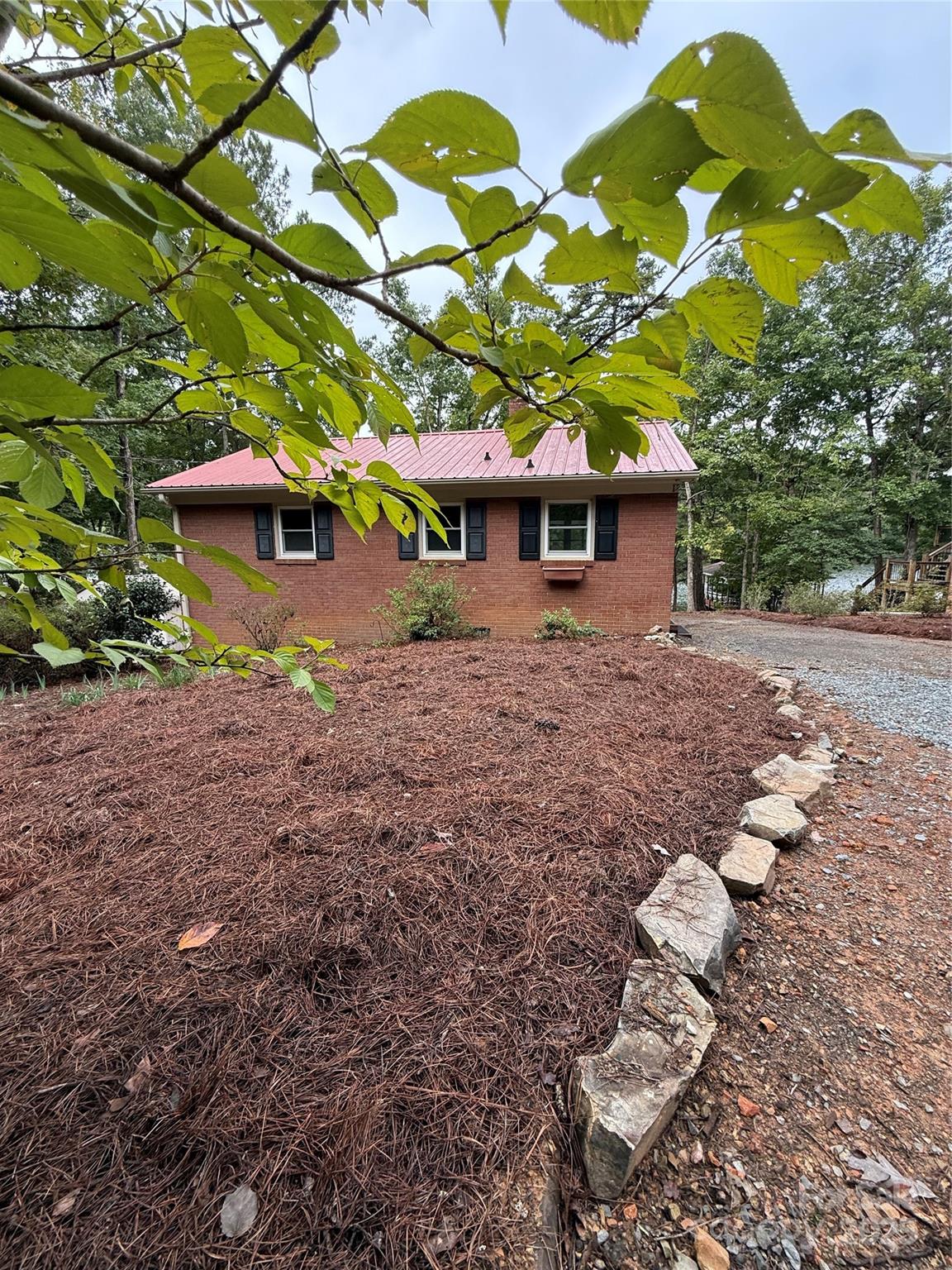 BACK ON THE MARKET after a new septic tank was installed. Buyer's could not wait, so it is back! A renovated water front property on Lake Tillery! This 2 bedroom, 1 bath, all brick, lakefront home has been beautifully updated. The kitchen has new white cabinets, new stainless steel appliances and solid surface countertops. The windows, exterior and interior doors are all new, energy efficient and finished nicely with black hardware. You will love the new paint and floor covering. Enjoy water front views from the living room, the back bedroom and the nice large deck with a ceiling fan. Home will accommodate a stacked or all in one washer dryer unit. The water is 5 - 7 feet at the end of pier, low water not an issue. The partial basement serves as a boat garage and crawl space has moisture barrier and a dehumidifier. The like-new paddle boat conveys. Piney Point Golf Club is a short walk or golf cart ride away. See their website for membership options. County water is available to hook onto, and the tap has been paid for, but property is currently on a community well which costs $250/year. There has never been an issue for the 5 people that share the well such as not being able to wash a car or pressure wash their home. A well report came out 2 months ago showing water is great. The property has lots of trees, and the trees that compromised the house have all been removed. The view across then lake has no homes, just trees.