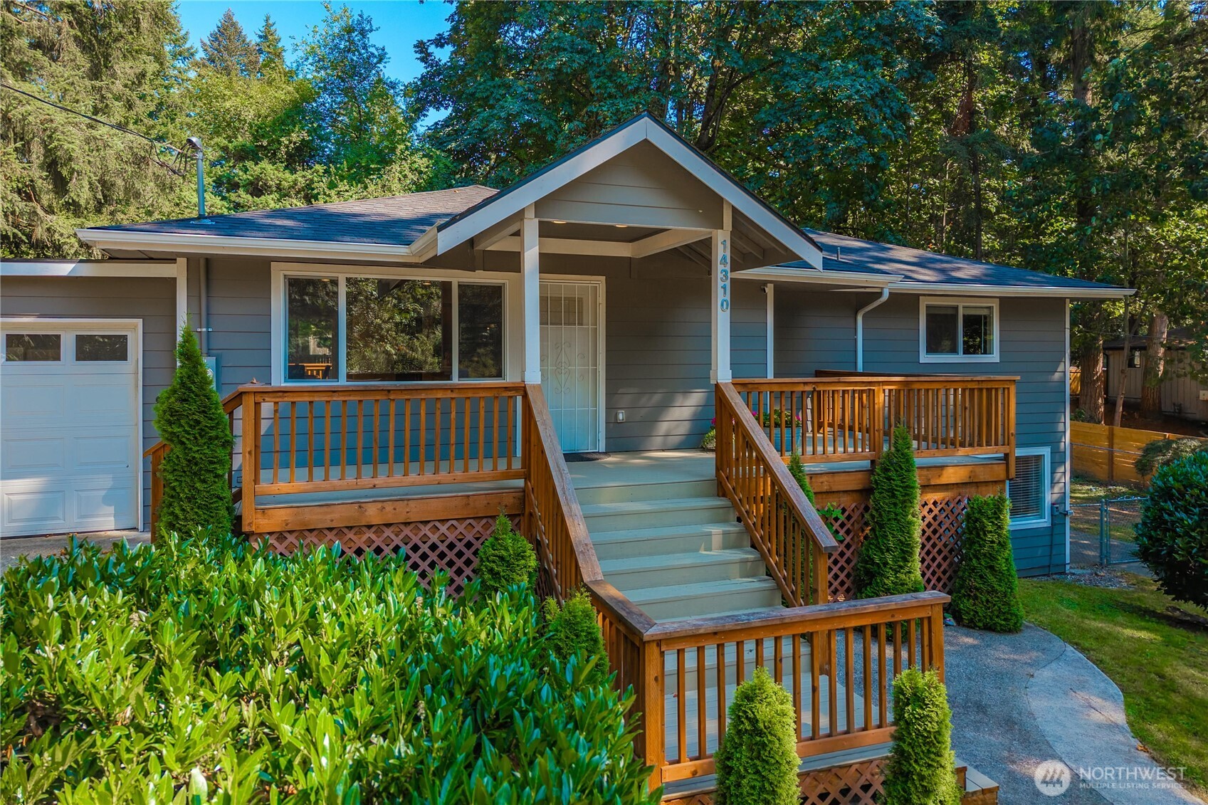 Spacious one-story home with a fully finished basement, tucked at the end of a private dead-end road in a desirable neighborhood served by Issaquah schools. With no HOA, a large newer covered carport, and an extra parking area, there is room for your toys, tools, and everyday parking needs. Updated in 2020, this 2,480 sq ft home offers a flexible layout, generous room sizes, and the kind of function that is hard to find. The open-concept main level features vinyl plank flooring, skylights, dining space, and a refreshed kitchen with quartz countertops, stainless steel appliances, gas range and easy connection to the main living areas. Mini-split heating and cooling on the main floor help keep the home comfortable through the warmer months. The spacious primary suite includes a walk-in closet with built-ins and bath with an oversized shower. Downstairs, the large family room is made for gathering, complete with a wet bar and separate exterior entry, creating excellent flexibility for multi-generational living, entertaining, extended-stay guests, or potential rental income The .44-acre lot gives you rare breathing room with garden space, a fenced yard, patio, and a large deck overlooking the backyard & basketball area. Additional highlights include new paint and carpet, attached garage, included appliances with washer, dryer, and refrigerator, and wiring for a generator. Conveniently located minutes to schools, shopping and a easy commute into the Eastside.