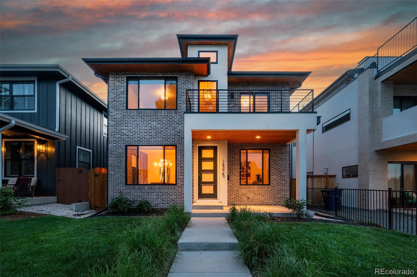 Refined modern living in this extraordinary contemporary residence located just steps from Sloan's Lake.  This 5 Bedroom // 4 Bathroom home offers a vaulted entry leading into an expansive main level wrapped in white oak flooring and flooded with natural light.  Open-concept design features a sophisticated great room with gas fireplace, sliding glass doors create seamless indoor-outdoor flow to the backyard, perfect for entertaining,a private main-floor office, and an elegant formal dining room and floating staircase. The gourmet kitchen is anchored by a large island with waterfall edge quartz countertops, two tone modern cabinetry, Jenn-Air appliances, a butler’s and a walk-in pantry with custom wine rack.  Upper level Primary Retreat lends a spa like ensuite 5 piece bath, chic tilework, soaking tub and walk in closet.  Two additional bedrooms, one with a balcony overlooking the lake and 2nd full bath complete the upper level.  Fully finished basement, wet bar, great room with surround sound prewires, two additional bedrooms and a full bath.  2 HVAC systems, tankless water heater, 2 Car Detached Garage and private fenced yard.  Walk 3 blocks to Odell Brewing, ChoLon, Stony's, Gusto and The Patio at Sloan's.