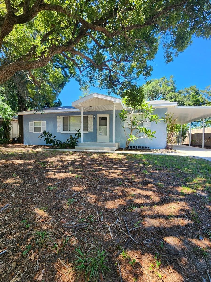 Location! Location! 3-bedroom, 2-bathroom, elevated-block ranch home with a one-car carport on a large 61' x 130' lot. Original hardwood floors in the living room, hallway, and 2 bedrooms. Updated kitchen luxury vinyl flooring, shaker-style wood cabinets, soft-close drawers, and pull-outs. Granite countertops, tiled backsplash, stainless steel double oven, microwave, and side-by-side refrigerator. Other features include double-pane windows and ceiling fans throughout. The hall bathroom features a wood vanity with a granite counter, a linen closet, and a jetted tub. The primary bedroom has wood-look laminate flooring and an ensuite bathroom with a shower. Inside laundry room with a stacked washer and dryer and a laundry sink. There is a Florida room in the back of the house with multiple windows and an abundance of natural light, and a door leading out to the fenced-in back yard with a 12'x10' shed. Quiet location on a dead-end street. Just minutes from Largo's new city center, shopping, parks, hospitals, and restaurants. 1/2 mile from the Pinellas trail and only 3 miles to the fine sand and sparkling waters of the Gulf of Mexico! This home is in a fantastic location and is ready for your personal touches to make it your own!