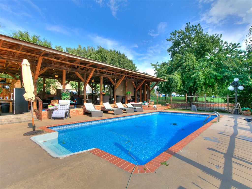 Spring is calling at 13 Southcliff. This expansive Southcliff estate is ready for warmer days, outdoor entertaining, and relaxed resort-style living—right in the heart of one of Norman’s most established communities.Designed for flexibility and space, the main home offers five-plus bedrooms, multiple living areas, and thoughtfully designed rooms that adapt to your lifestyle. The chef’s kitchen anchors the home with a large center island, brick backsplash, breakfast nook, and generous cabinetry—perfect for hosting everything from casual brunches to holiday gatherings. Formal and informal dining spaces flow into the family room, highlighted by a fireplace and warm wood accents. A dedicated theater room, music room, and multiple flex spaces provide endless options for work, play, or creativity.The primary suite is a true retreat, featuring a fireplace, sitting area, and spa-inspired bath—ideal for unwinding after a day by the pool. Secondary bedrooms are spacious and well-appointed, offering comfort and privacy throughout.One of the home’s most distinctive features is the private guest apartment with its own entrance, living room, full kitchen, bedroom, and bath—perfect for multi-generational living, long-term guests, or private workspace.As spring approaches, the backyard truly steals the show. Enjoy your resort-style pool, covered patio, expansive deck, and beautifully landscaped grounds complete with a koi pond and pergola. This outdoor setting is made for entertaining, relaxing, and soaking up Oklahoma’s best seasons.Additional features include a two-car garage with circle drive, abundant storage, and a location just minutes from shopping, dining, and top-rated schools.If you’ve been waiting for the right time to make a move, this is it. With warmer weather ahead, 13 Southcliff offers the space, flexibility, and outdoor lifestyle today’s buyers are searching for.