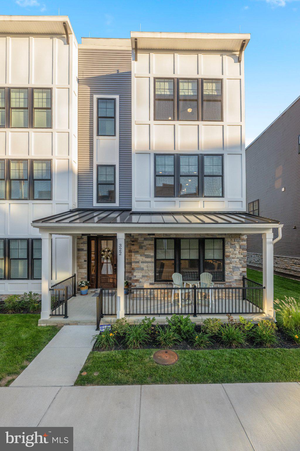 Welcome to 322 W Squire Drive—a rare opportunity in the sold-out and highly sought-after community of Newtown Walk at Ellis Preserve. Completed in 2025, hardly lived in and truly turnkey, this stunning luxury end unit townhome offers the exceptional opportunity to enjoy virtually new construction without the wait. Quietly positioned within the community, a lovely front porch welcomes you into an interior that feels fresh, sophisticated and completely timeless. High ceilings throughout, abundant natural light and exquisite finishes create a wonderful sense of openness and scale, while gleaming hardwood floors connect the spaces with a seamless flow. A neutral, classic palette provides an elegant backdrop that will stand the test of time. Offering 3 Bedrooms and 3.5 Baths across four beautifully finished levels, the home has been thoughtfully designed for effortless everyday living and entertaining. The first level features a private ensuite Bedroom, ideal for overnight guests or as a flexible space to suit your lifestyle, along with an oversized attached two-car Garage. Adding an exceptional level of convenience, the private elevator begins at the Garage level and provides access to all four levels of the home—making everything from groceries and luggage to everyday living wonderfully easy. The second level is truly the hub of the home, with a fabulous open layout designed equally well for relaxed day-to-day living and effortless entertaining. At its center is the gourmet Kitchen with a large center island that naturally becomes a gathering place, beautifully flanked by a spacious Family Room and generous Dining Area. The Family Room is anchored by a gas fireplace flanked by handsome custom built-ins and cabinetry, adding both architectural interest and wonderful functionality to the space. Hardwood floors seamlessly connect each area, creating one expansive yet inviting living environment. A dry bar with beverage refrigerator adds another thoughtful touch, perfect for everything from morning coffee to evening cocktails. Open, inviting and filled with natural light, this is the floor where everyone will naturally want to gather The third level is home to the Primary Bedroom, a serene sanctuary with a beautifully custom-outfitted walk-in closet, along with an additional Bedroom featuring its own custom-designed closet. Crowning the home is the fabulous rooftop deck, a private outdoor retreat with stunning views and the perfect setting for morning coffee, sunset cocktails or evenings under the stars. Here, luxury extends well beyond the walls of the home. The HOA provides the ease of a lock-and-leave lifestyle with lawn care, landscaping and snow removal taken care of for you. This is not simply a home—it’s a lifestyle. Walk to Whole Foods Market, luxury shopping, charming cafés and an incredible selection of restaurants to choose from at Ellis Preserve, while the beautiful walking trails of the historic Charles Ellis Estate are just minutes away. With convenient access to major highways, the location offers an exceptional combination of tranquility, walkability and connectivity. Sophisticated yet comfortable, polished yet easy, 322 W Squire Drive is a rare chance to move in, unpack and immediately enjoy the best of Newtown Walk and Ellis Preserve. SHOWINGS BEGIN THURSDAY SEPTEMBER 17TH.