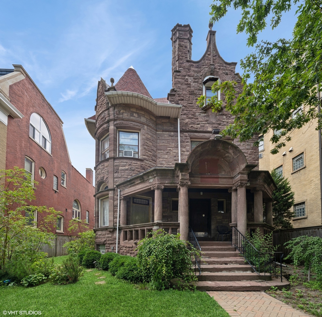 Extraordinary opportunity to own this classic Chicago mansion with 8 bedrooms on a 50 x 150 foot lot. This RT-4 zoned, 1905 stone home boasts 3 floors of living space and has undergone restoration work to reveal some of its jaw dropping vintage craftsmanship. Situated in an ideal Uptown location this property is located in close walking distance to the Wilson Red Line and Purple Line express lines, several bus lines and the Broadway Target and Aldi. Step through the gate and into your fully fenced in front and side yard complete with huge stone porch. A stunning floor mosaic greets you as you enter through a dual set of double wooden doors into the grand foyer with original stained glass and a resorted wooden staircase. Rich decorative hardwood flooring throughout this level welcomes you into a huge living room space with an enormous formal dining room complete with coffered ceiling, custom cabinetry, buffet and extraordinary fireplace. An ample sized kitchen in the back of the house has been lovingly updated with modern stainless steel appliances including a dishwasher. The kitchen is flanked by both a laundry / storage room and walk-in pantry. An updated and convenient half bath located below the stairwell. Up the grand and ornate staircase you'll find two more floors of living space with 8 large bedrooms and 3 additional baths, which have been updated. The room sizes are varied, but all large and homey. There is also a great room on the top floor with soaring ceilings that is currently used as a recreation room, but can also be used as a bedroom. The lower level is finished and could be updated to create even more living space. It has a newly updated boiler (2018) and is currently used as a large storage space. You'll feel the extra wide lot in the large backyard fitted with a stone patio, lawn and garden perfect for relaxing and entertaining. Additionally, the property comes with a total of 5 exterior parking spaces. The many possible uses for this home include; short term rental, development, TOD, commercial, or office spaces. Don't miss out on the opportunity to own this piece of Chicago history.