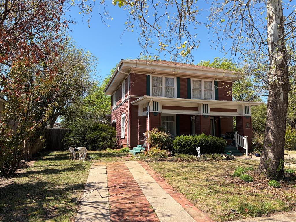 Walk to campus and downtown arts district from this CHARMING, HISTORIC  two story Prairie style home in Miller Historic District.   Hardwood floors. MAIN LEVEL : Formal Living and Dining, kitchen with gas built stove, granite, dishwasher, dining, sitting area with original fireplace, opens to deck with private garden.UPSTAIRS : 3 Bedrooms, plus Full bath and kitchen (which could be another bedroom) Possible Mother-in -law suite.
