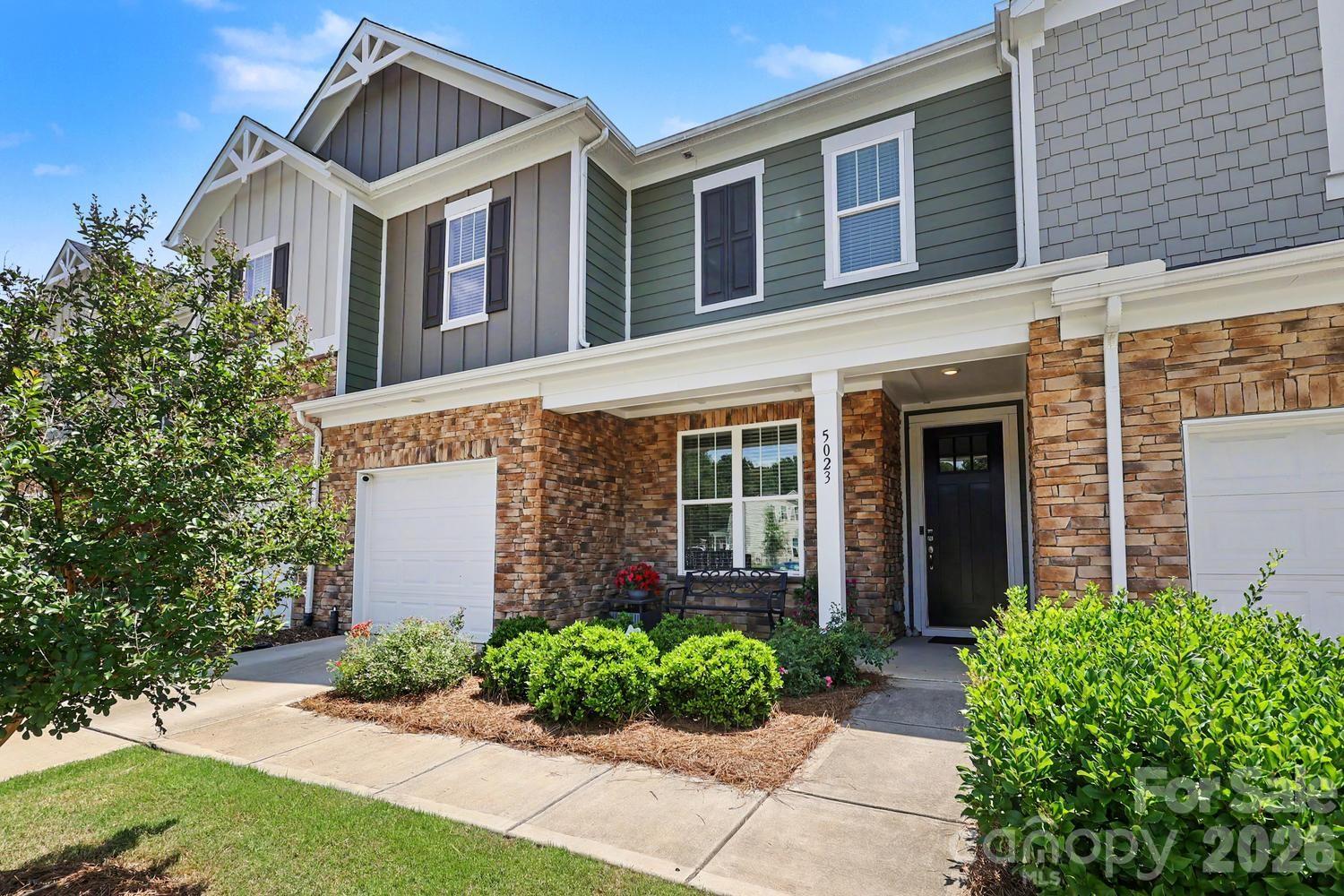 Your opportunity to own a 4-bedroom townhome with garage and over 2,100 square feet in The Vineyards on Lake Wylie, one of the area's most amenity-rich, resort-style lake front communities. Residents enjoy access to multiple pools, dog parks, tennis courts, new clubhouse, fitness center, pickleball and bocce courts, playground, lakeside walking trails, boardwalk, kayak and boat launch, boat storage, and the opportunity to purchase private boat slips (subject to availability). Pride of ownership shows in the thoughtfully designed open-concept floor plan offering exceptional flow for everyday living and entertaining.  The spacious kitchen serves as the heart of the home, featuring a large center island with seating, and a premium Frigidaire Gallery® stainless steel appliance suite, including an electric range with integrated Air Fry technology.LVP flooring extends throughout the main level, while oversized windows fill the living and dining areas with natural light. A flexible main-level bedroom is currently used as fitness space, providing versatility to meet a variety of work and lifestyle needs. A custom wine alcove with decorative wrought-iron door adds character to the living space.  The builder included enhanced sound insulation between the units to help minimize noise transfer. The home is equipped with a Kinetico® Filtration and Water Softening System for enhanced water quality throughout the home.  An ADT Security System, complete with cameras and sensors convey.Step outside to a private fenced lawn area designed for relaxation and enjoyment with white stone pathways and blooming rose garden. Conveniently located just minutes from Charlotte Douglas International Airport, the  developing River District, Belmont, and Uptown Charlotte.