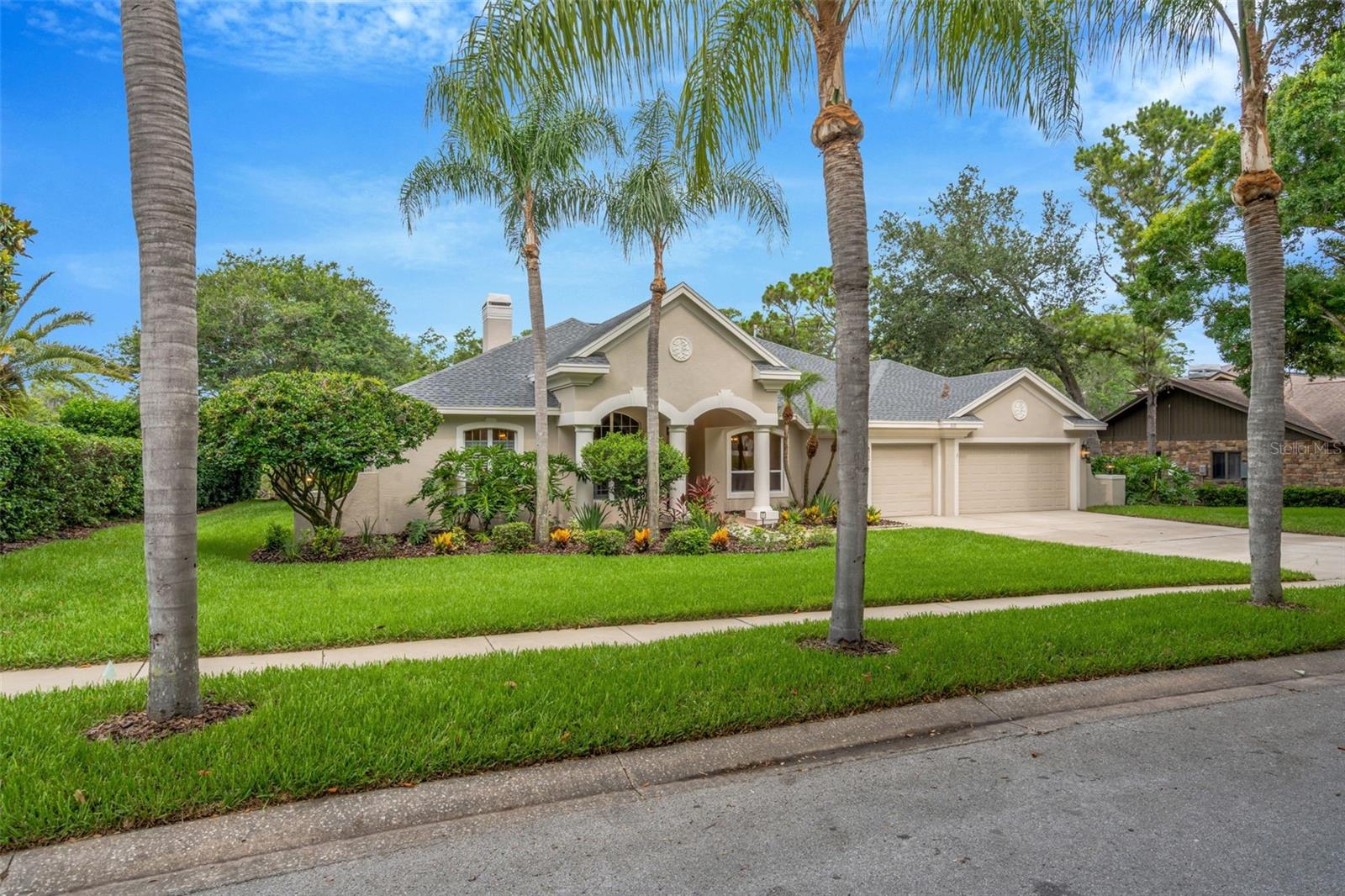 Virtually Staged. Welcome to this stunningly updated 5-bedroom, 3-bath waterfront estate situated on an expansive 0.83-acre homesite in the highly sought-after Autumn Woods community of Palm Harbor. Offering 3,540 square feet of beautifully renovated living space and breathtaking water views, this exceptional residence combines luxury, comfort, and functionality in one remarkable package. From the moment you enter, you'll appreciate the extensive updates throughout, including new flooring, fresh interior paint, a completely redesigned chef's kitchen, and high-end finishes at every turn. The heart of the home features brand-new quartz countertops, a massive center island with seating, new stainless steel appliances, a natural gas cooktop, and a dual wall oven/microwave combination with convection cooking in both units. Thoughtful details such as the large stainless kitchen sink with integrated cutting board and drying rack elevate both form and function. Designed for entertaining and everyday living, the home offers formal and casual dining spaces, including a formal dining room, breakfast nook, and generous island seating. The spacious living room showcases a cozy gas fireplace, while custom built-ins in both the living and family rooms add elegance and practicality. The luxurious primary suite serves as a private retreat, complete with dual walk-in closets and a spa-like bath featuring dual vanities and abundant space. A large bonus room provides endless possibilities as a game room, playroom, home office, media room, or even a sixth bedroom. Step outside to your private backyard oasis, where a screened pool and heated spa overlook tranquil pond views. The expansive lanai offers ample space to create the ultimate outdoor living experience, with room for a full outdoor kitchen, dining area, and additional entertaining area. Additional highlights include a spacious interior laundry room with utility sink and storage cabinetry, abundant natural light throughout, and a highly desirable location within one of Palm Harbor's premier communities. Residents of Autumn Woods enjoy exceptional amenities including tennis and basketball courts, playground, dog park, community park, and beautifully maintained common areas. Conveniently located near top-rated schools, championship golf, Gulf beaches - including Honeymoon Island and Caledesi Island, shopping, dining, and everything Palm Harbor has to offer, this is a rare opportunity to own a truly exceptional home in one of the area's most prestigious neighborhoods. Be sure to check out the video walk-thru and virtual tour.