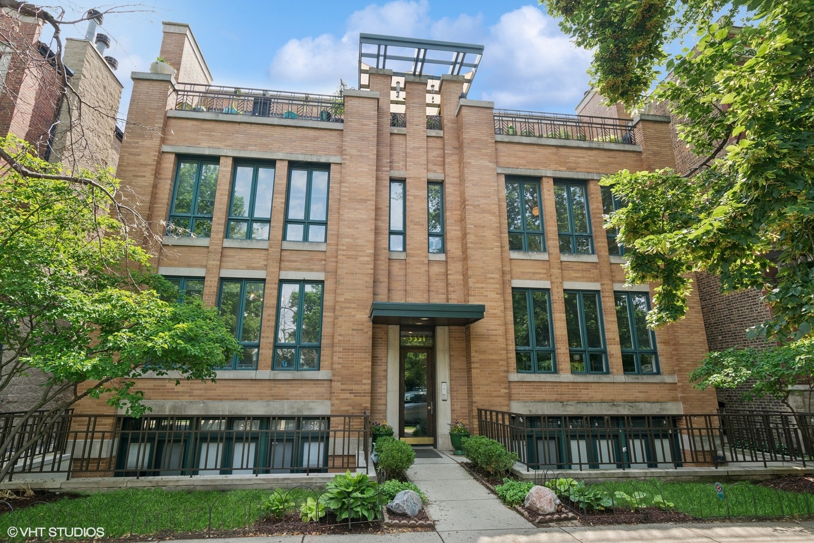 Welcome home to this extra-wide 3bed/2bath condo with Living Room and Family Room on same level. This is not a cookie cutter floor plan. Upon entry, notice the wide hall and ample storage. The front Living Room/Dining Room has gorgeous floor to ceiling windows for excellent natural lights, beautiful hardwood floors and a gas fireplace w/ flue. The Primary Suite features large dual closets, and the Primary Bath has upgraded fixtures & lighting, separate tub and shower. The 2nd and 3rd bedrooms are large w/ ample closets. The kitchen and Family room face east for amazing morning light. The kitchen has quartz tops, under-cabinet lighting, new fixtures, tiled backsplash and plenty of storage. The East-facing Family Room opens to a large deck and rear stairs up to a 2nd outdoor space above your home. Wonderful green space and a playground right across the street. Conveniently located near the Southport Corridor, Wrigley Field, and Red/Purple/Blue/Brown Line Belmont Station. Seminary is a one-way, wide, quiet street. One of the best blocks in Lakeview! Garage parking included. Association recently made garage EV-charger capable. NOTE: Upper level terrace space is a shared space.