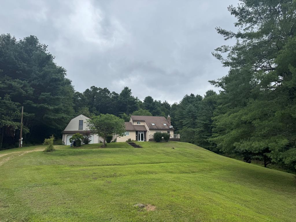 Discover your own piece of Blue Ridge paradise! This charming mountain home sited on a beautiful 26 acre setting in Grayson County, VA offers the perfect balance of privacy, outdoor adventure, and convenience. Just minutes from the Grayson Highlands State Park, the famed New River, and native trout streams, this property is a haven for nature lovers, anglers, and anyone seeking a peaceful mountain retreat or primary residence.  Enjoy the serene setting with rolling land, mature trees, and plenty of space for gardening, recreation, or even a small farm. The detached 2-car garage offers a bonus space on the upper level that can easily be converted into living space for overnight guests or extended family. Whether you're looking for a full-time residence, vacation getaway, or investment opportunity, this property provides the perfect canvas for mountain living.